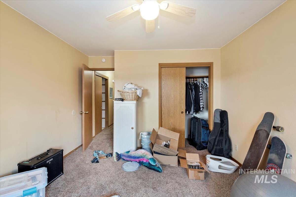 Bedroom featuring a closet, carpet floors, and a ceiling fan