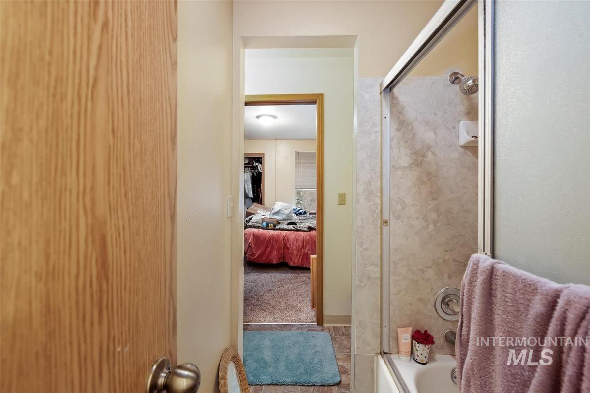 Ensuite bathroom with tile patterned floors