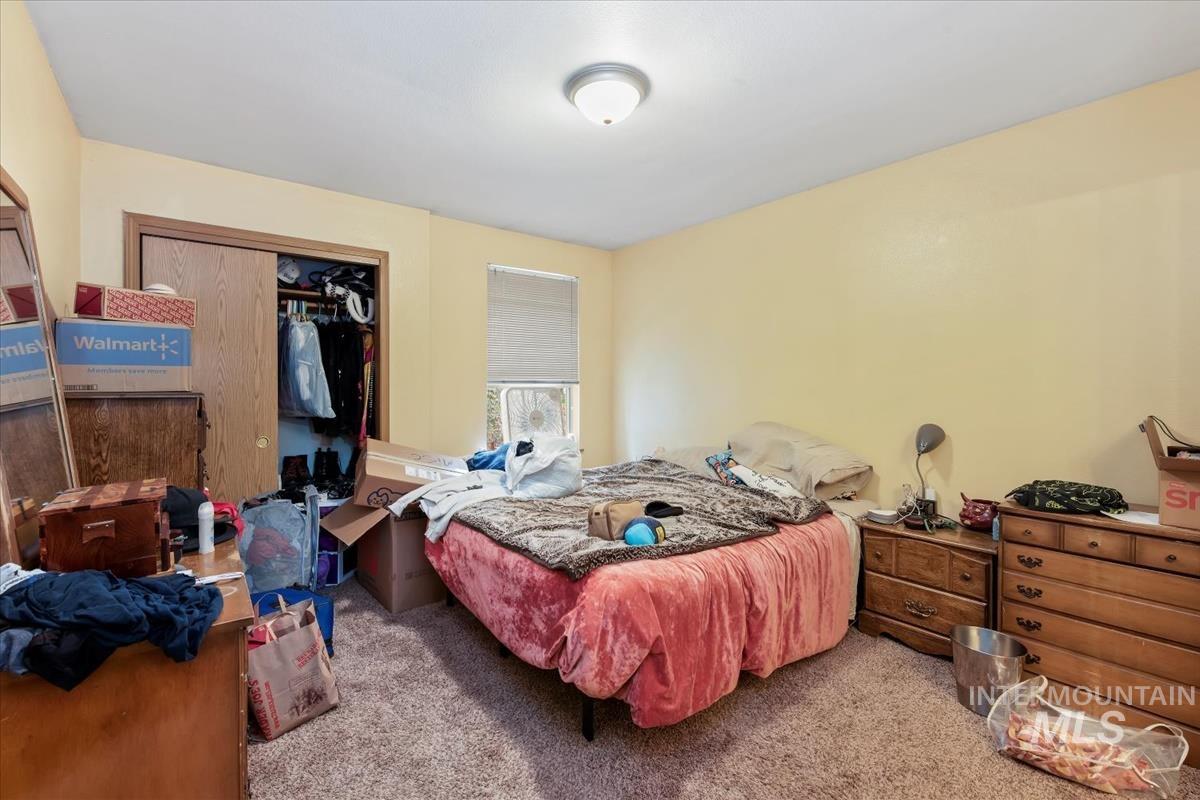 Bedroom with carpet floors and a closet