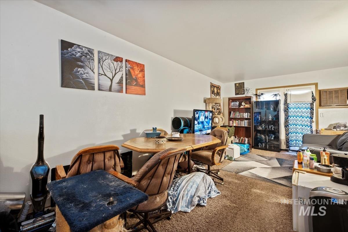 Home office featuring carpet floors and a wall unit AC