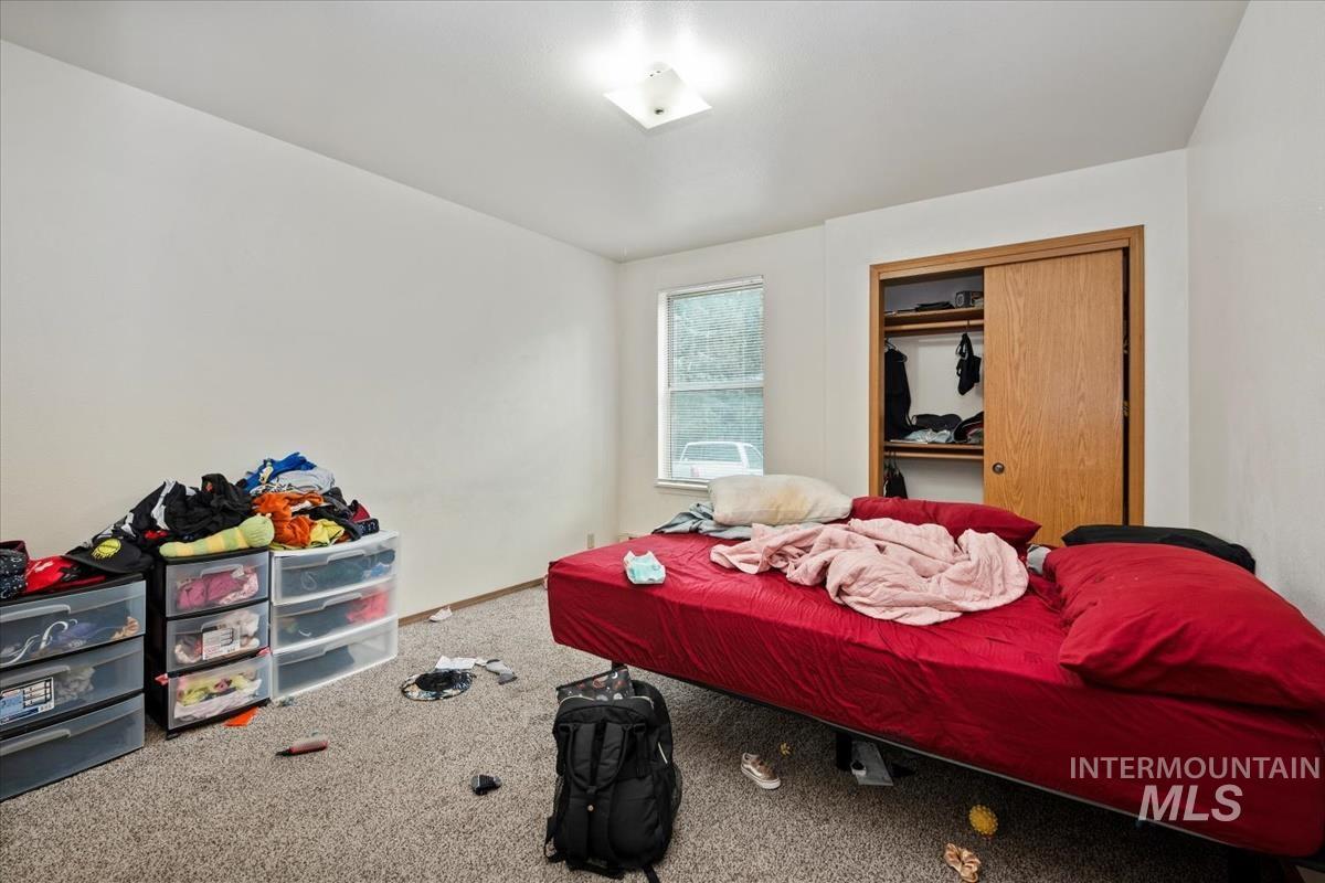 Bedroom with carpet floors and a closet