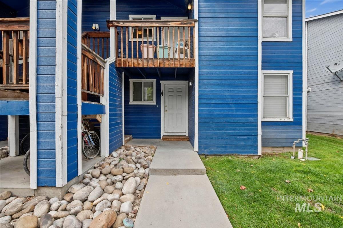 View of exterior entry with a lawn