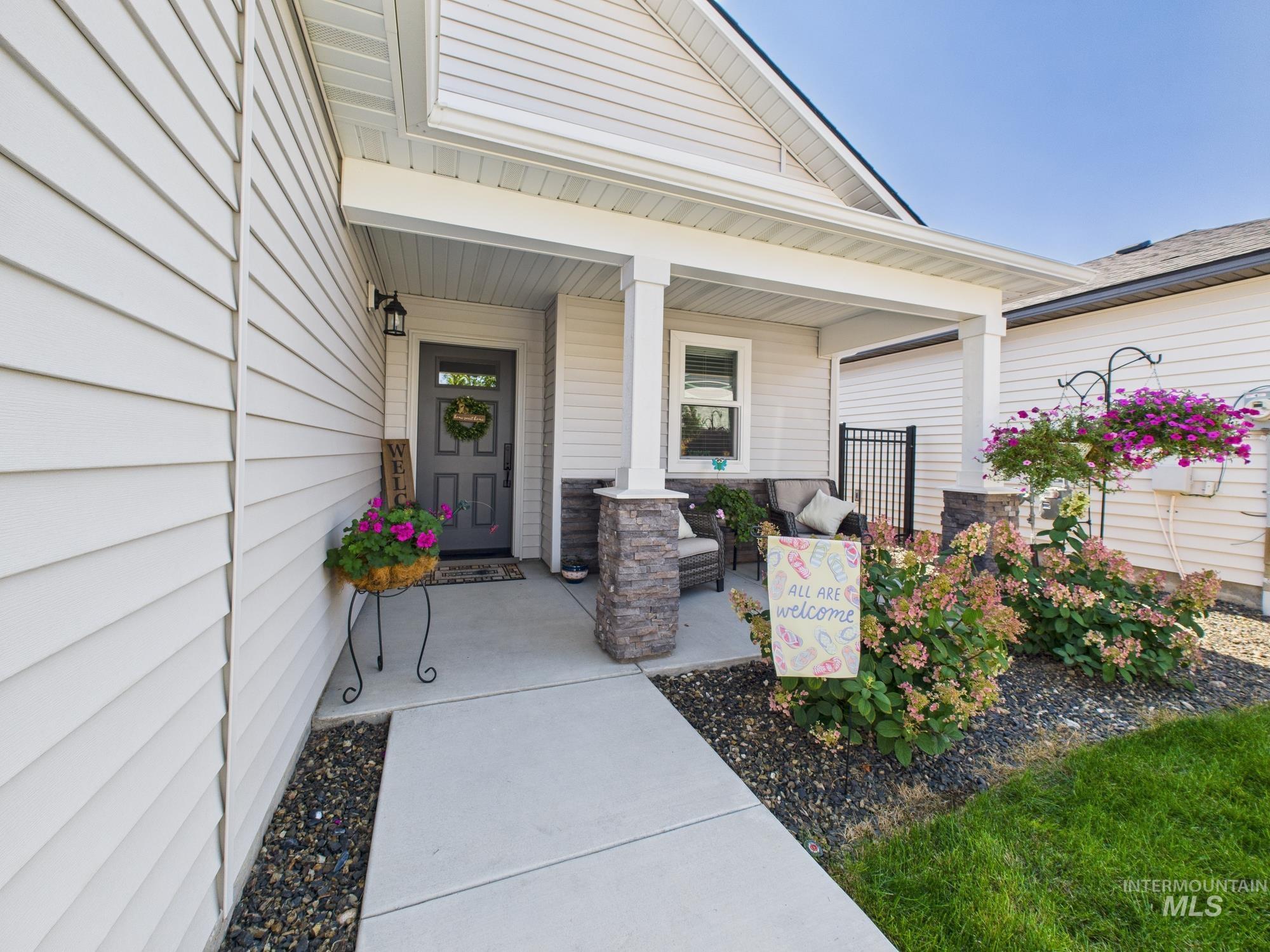 Doorway to property featuring covered porch