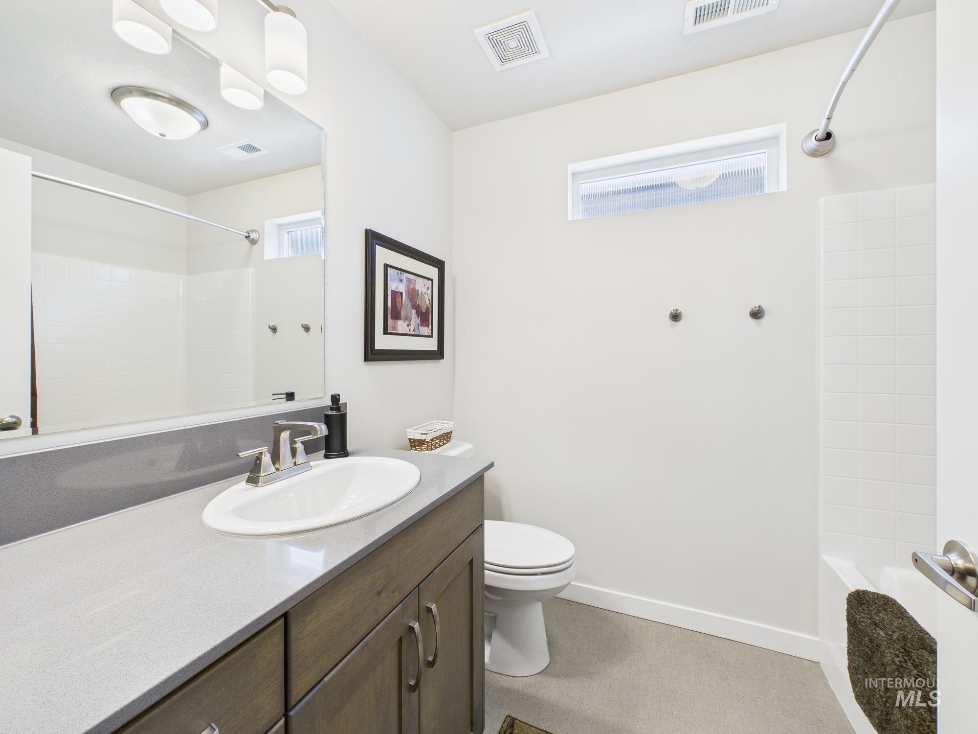 Bathroom featuring vanity and shower / bath combination