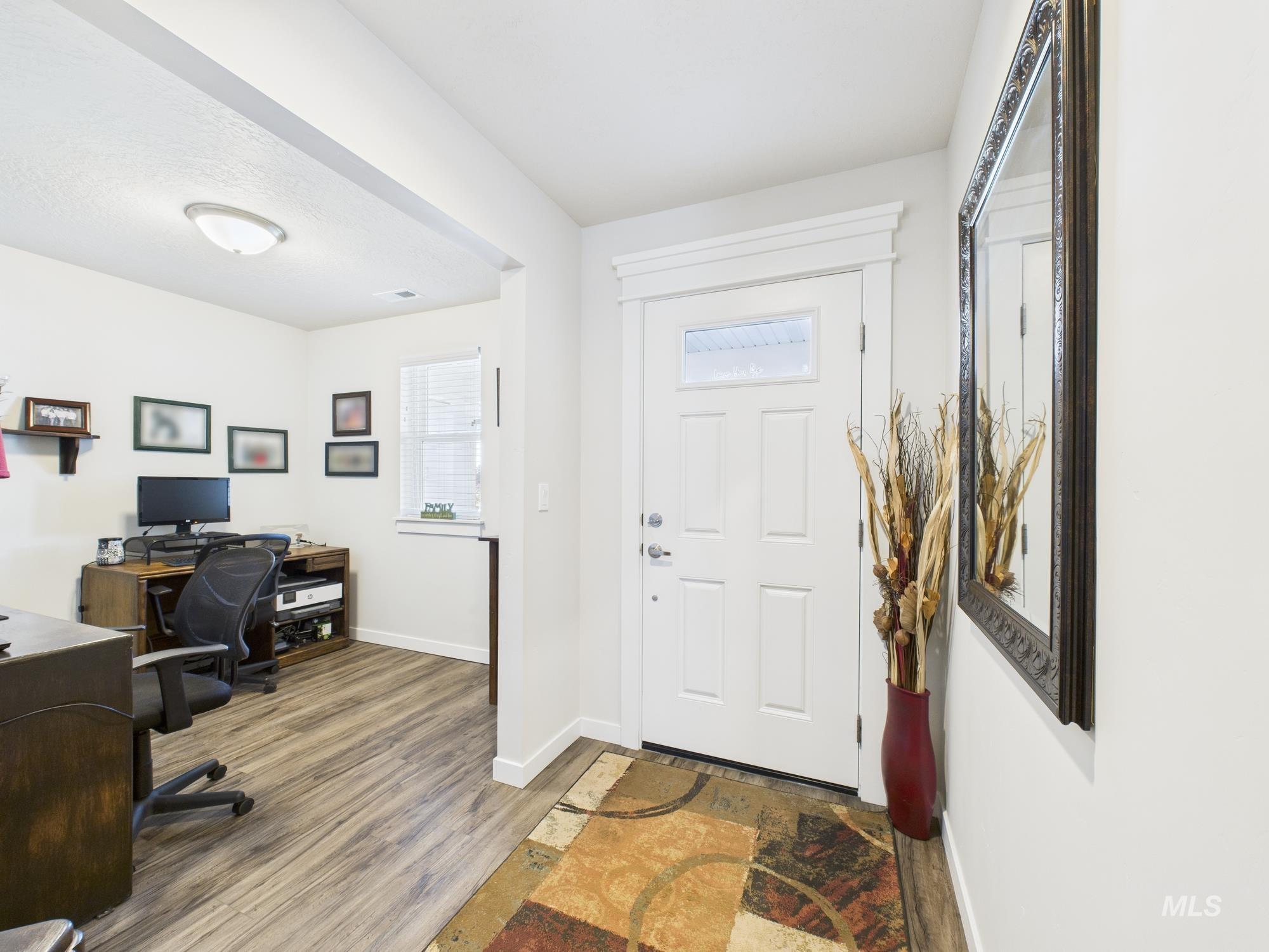Entryway featuring baseboards and light wood finished floors