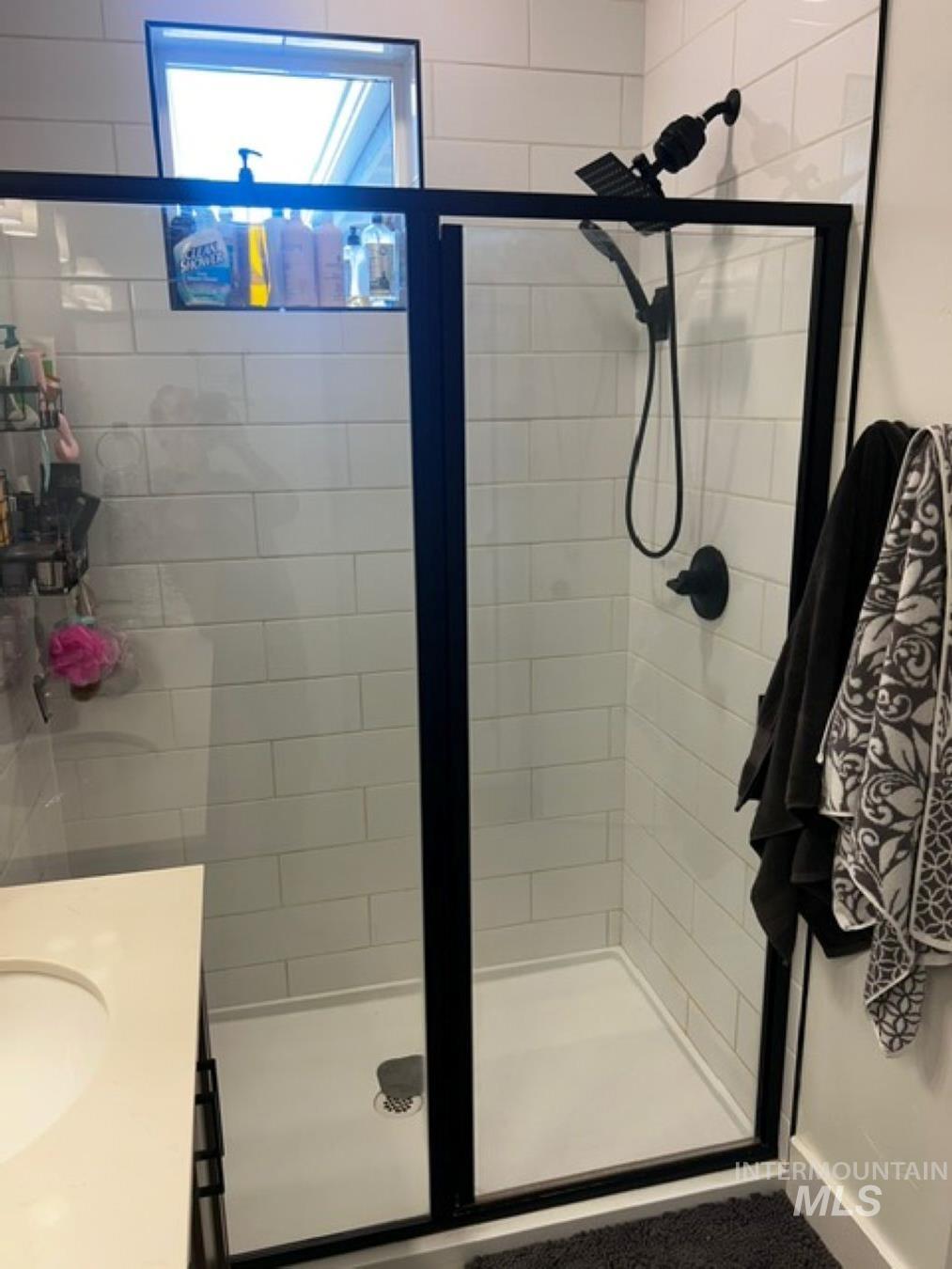 Bathroom featuring vanity and a stall shower