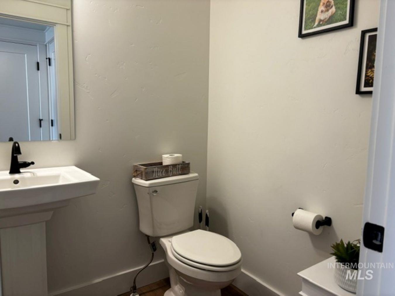 Bathroom with toilet and baseboards