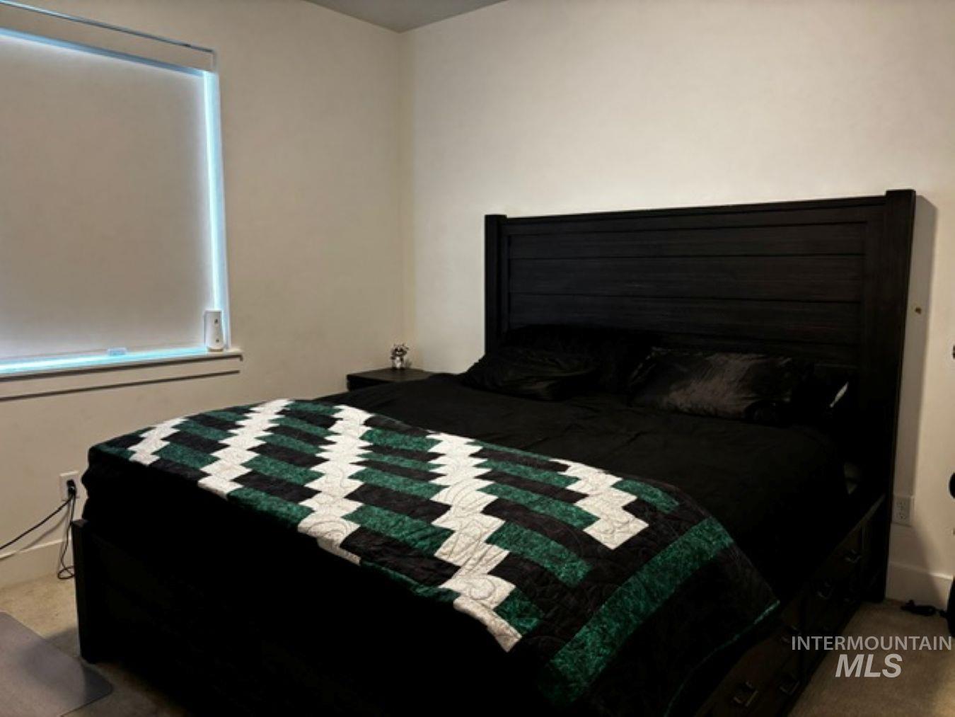 Bedroom featuring light carpet