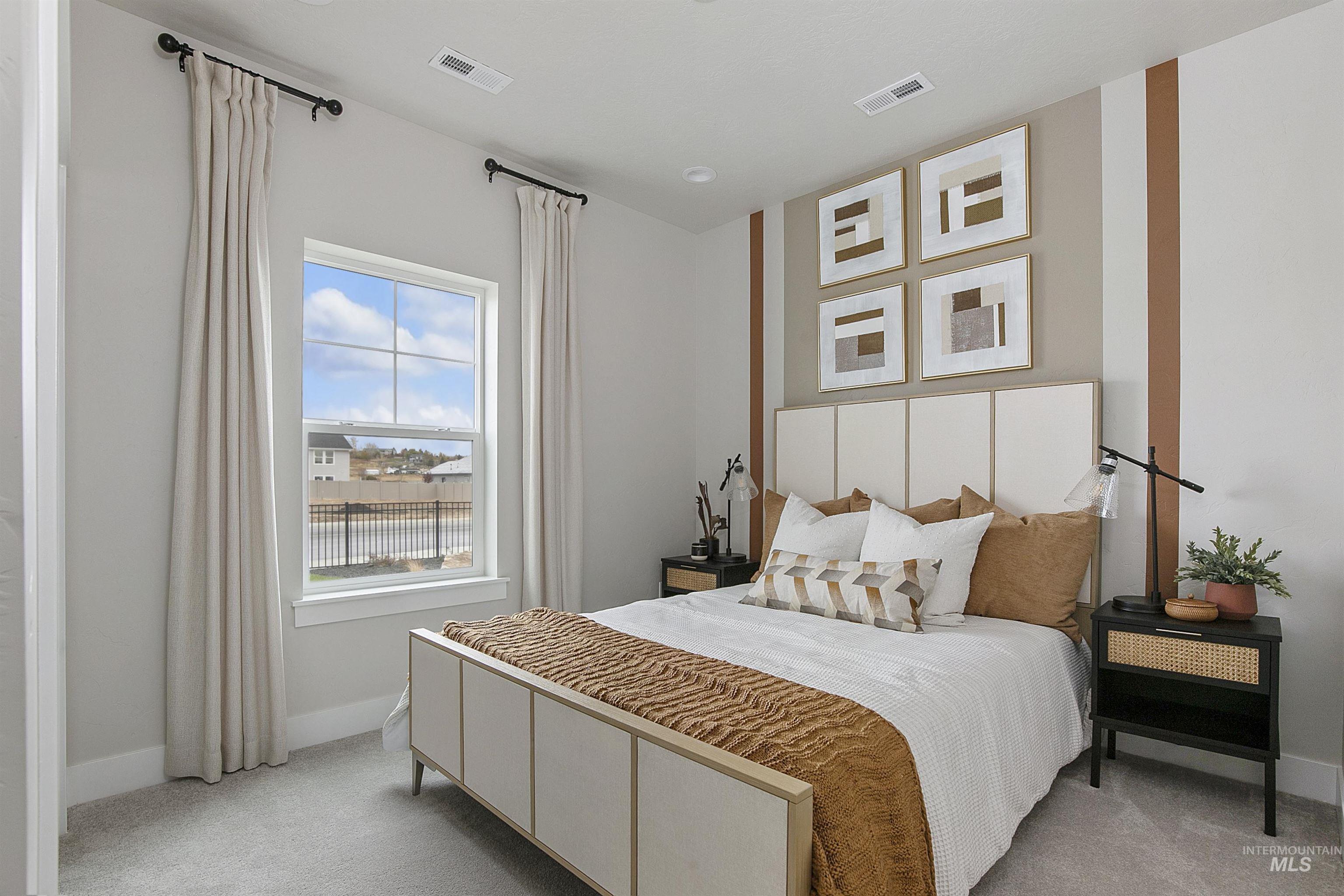 Bedroom featuring light colored carpet and baseboards
