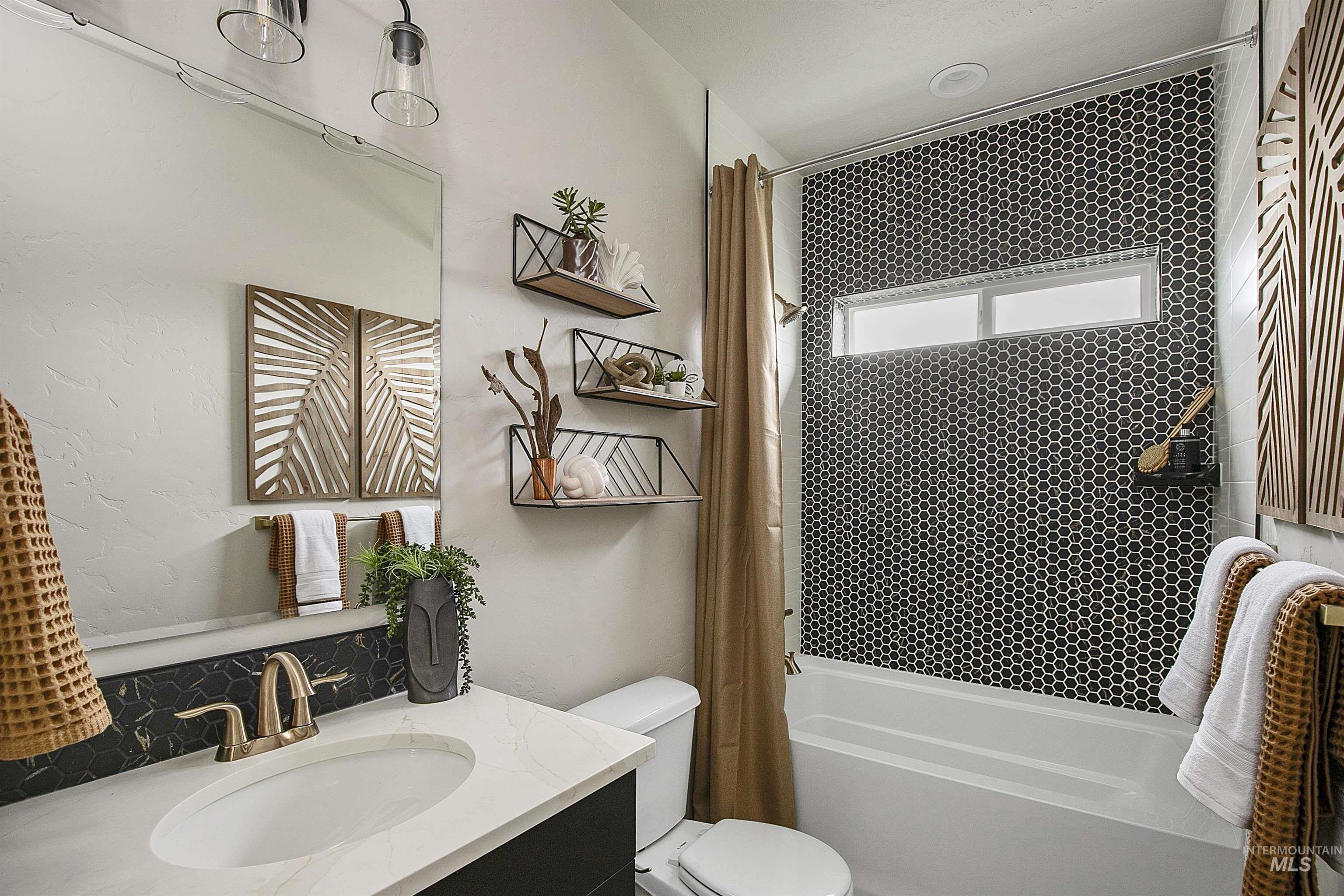 Bathroom featuring shower / tub combo and vanity
