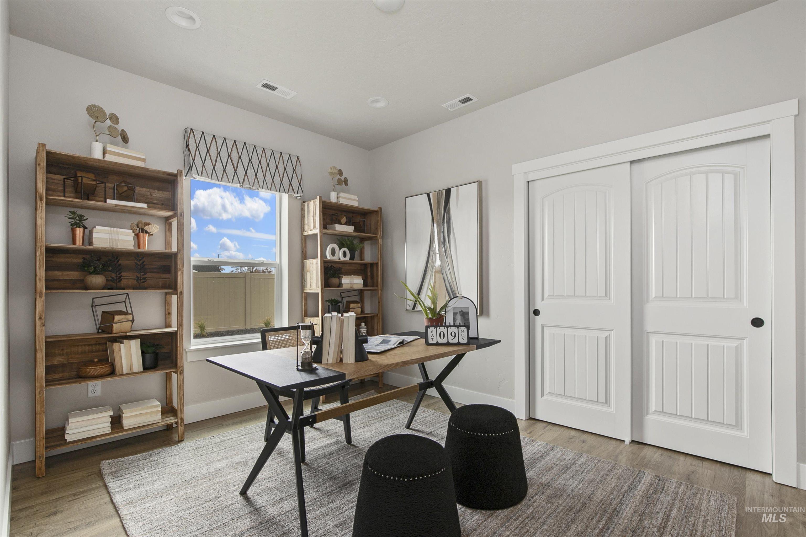 Home office featuring light wood finished floors and baseboards