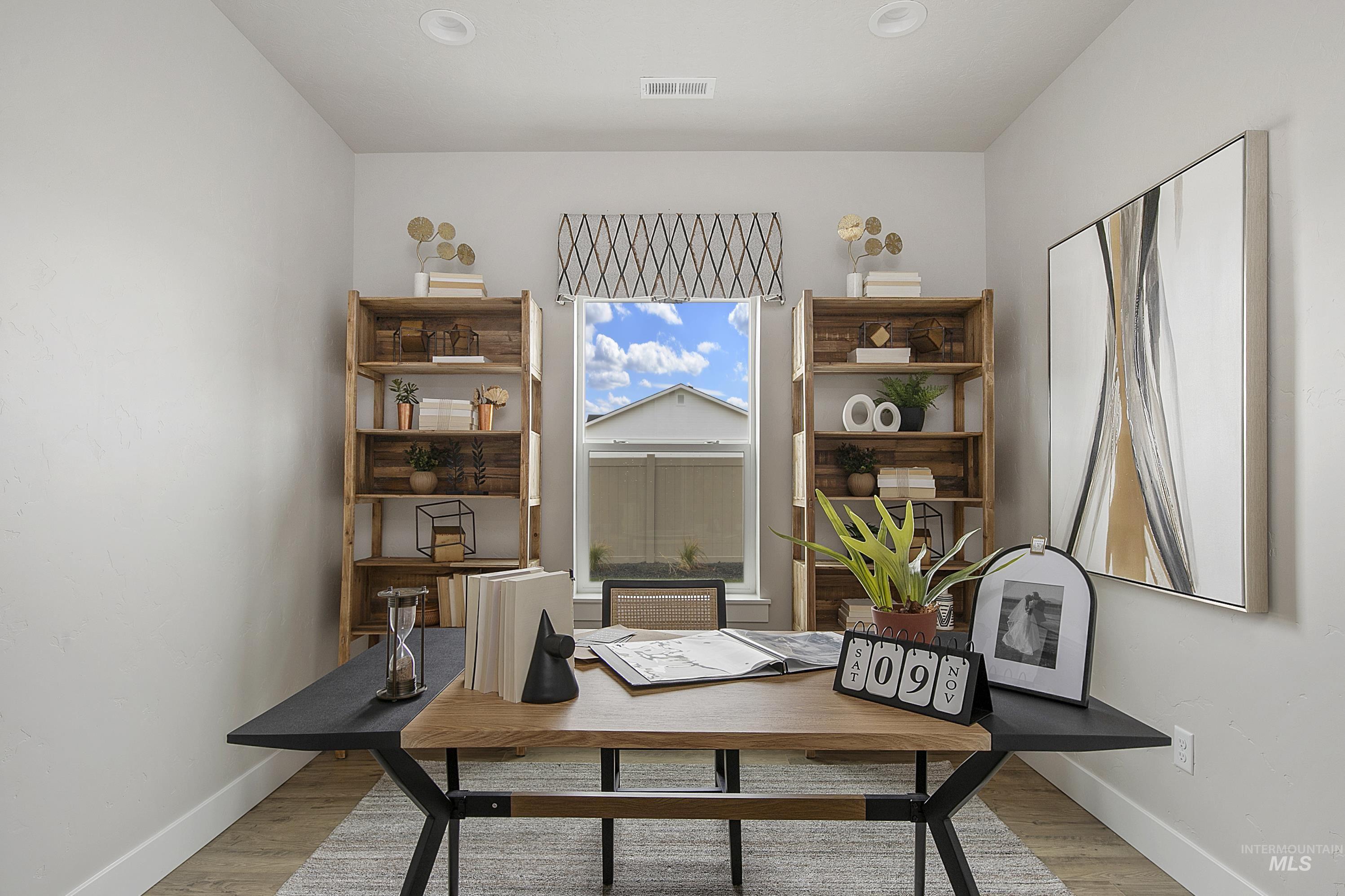 Home office with baseboards and light wood-style floors