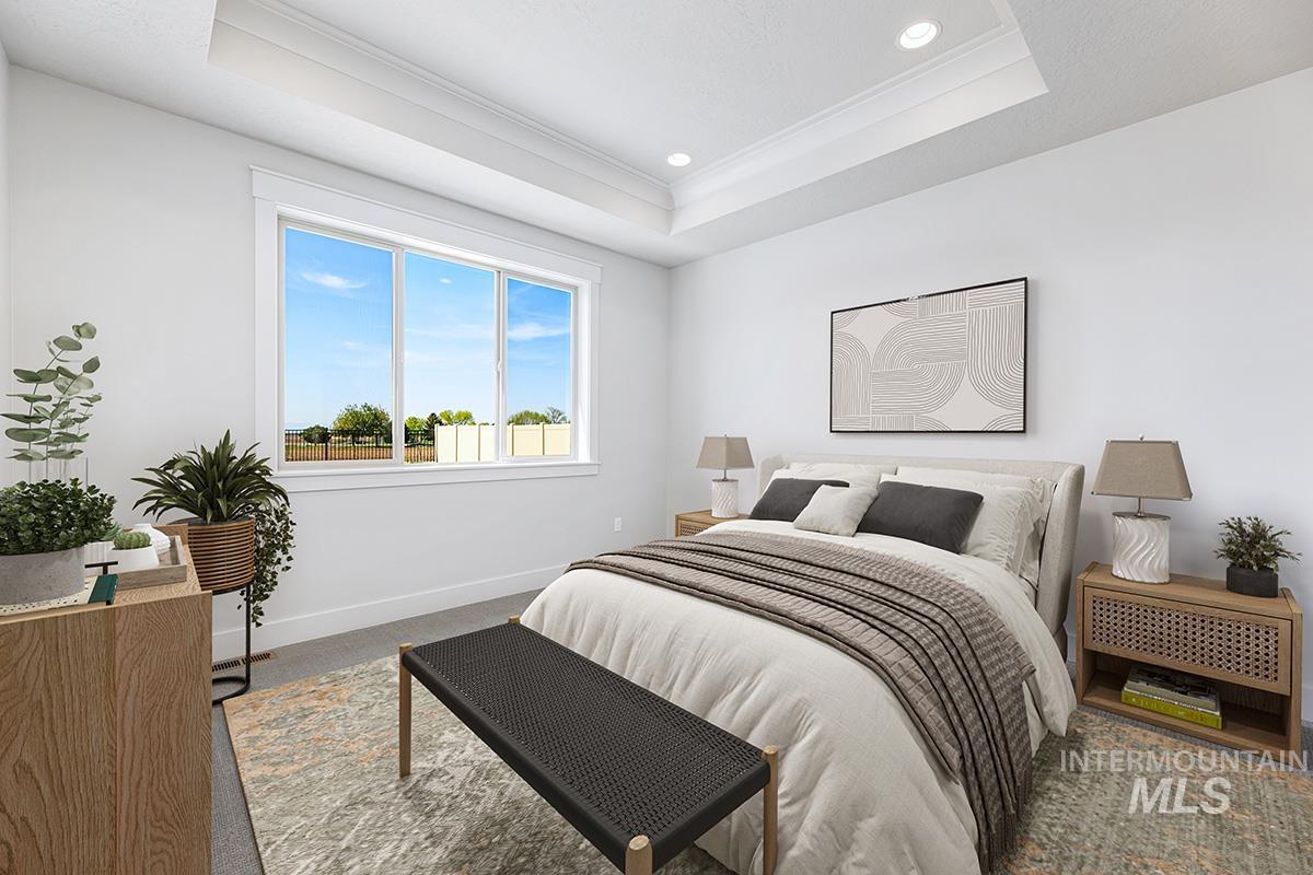 Bedroom with a tray ceiling, carpet, ornamental molding, and recessed lighting