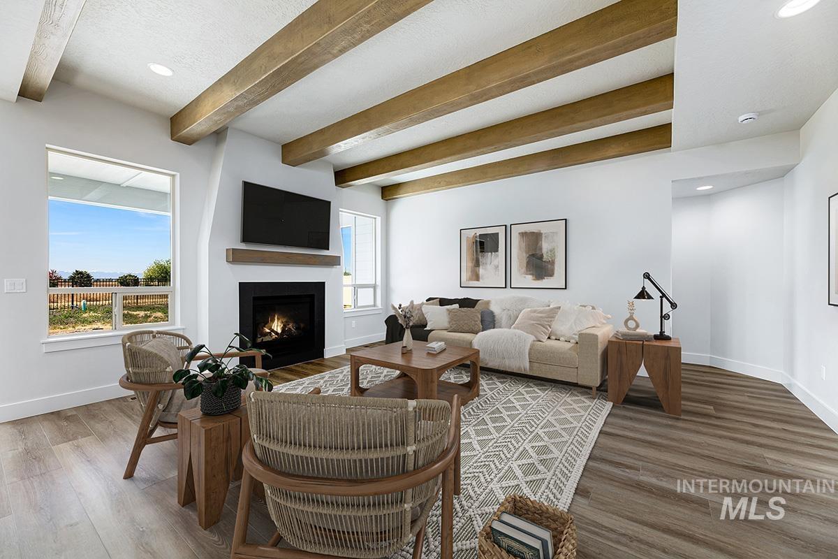 Living area featuring recessed lighting, beam ceiling, a fireplace with flush hearth, and wood finished floors