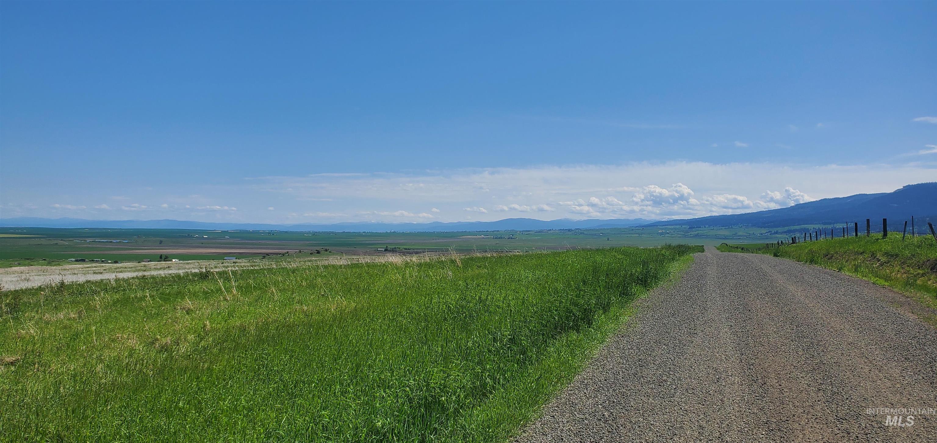 View of mountain backdrop with rural landscape