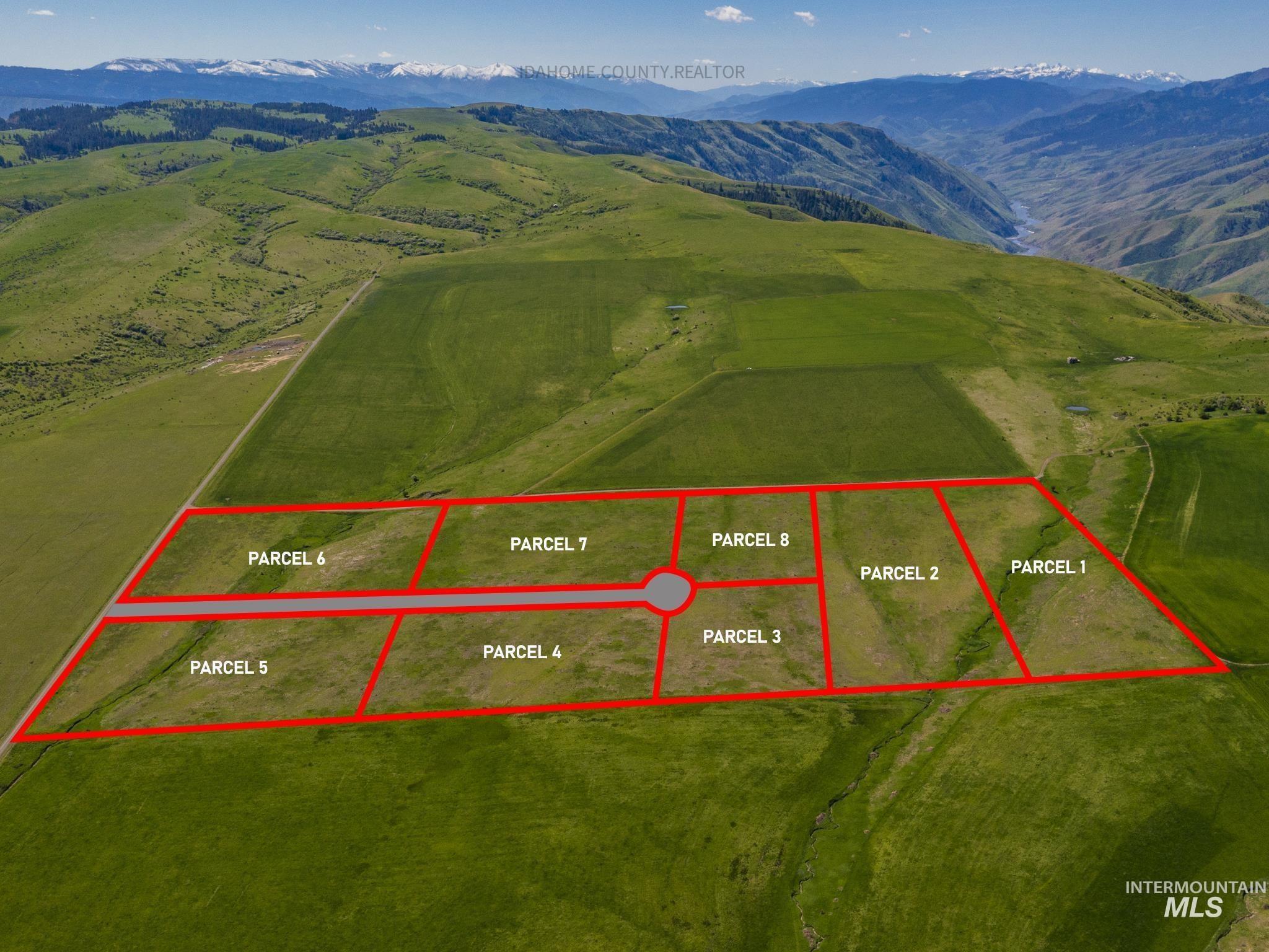 Aerial view of property's location featuring a mountainous background and property parcel outlined