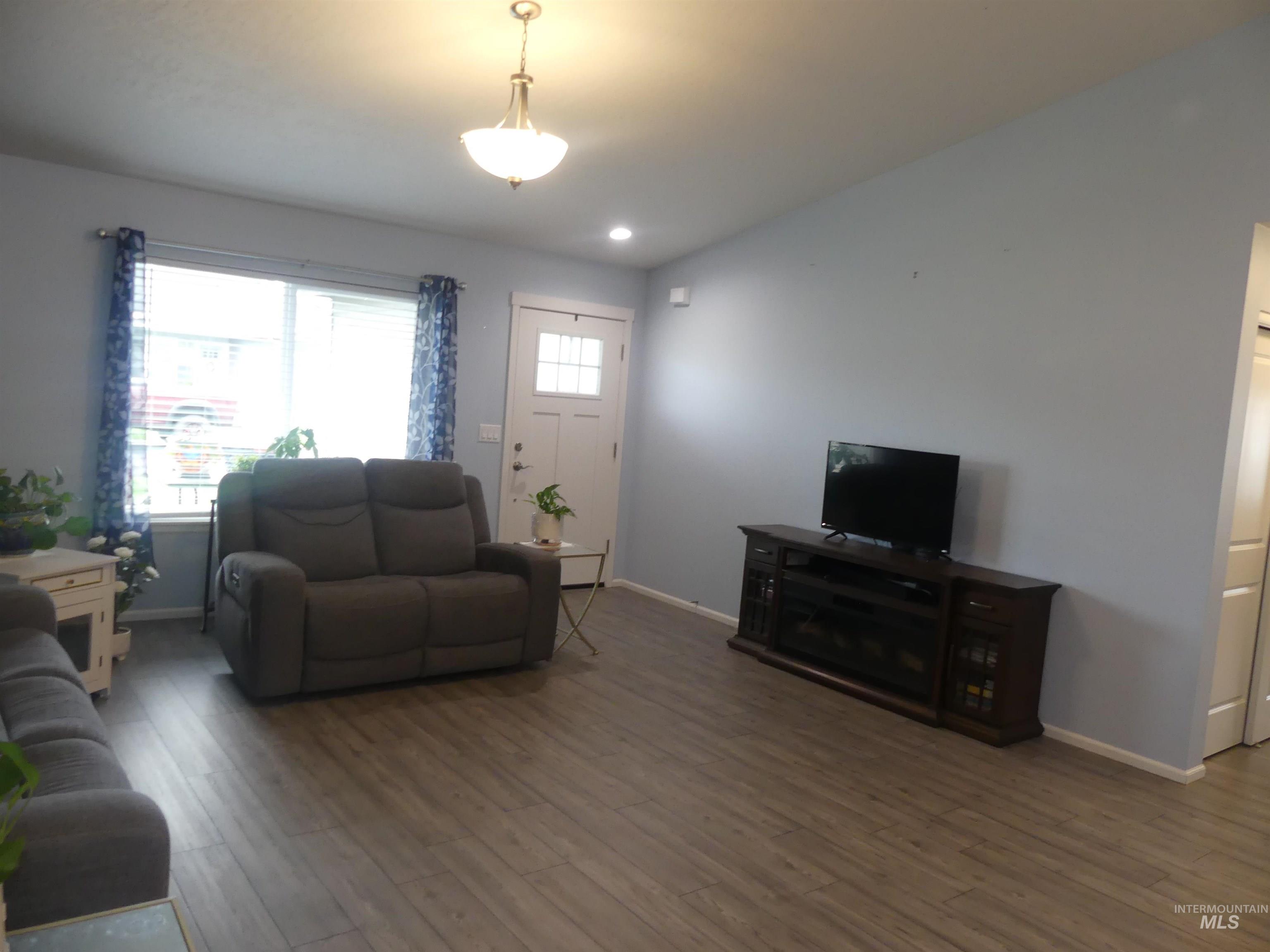 Living area featuring wood finished floors and recessed lighting