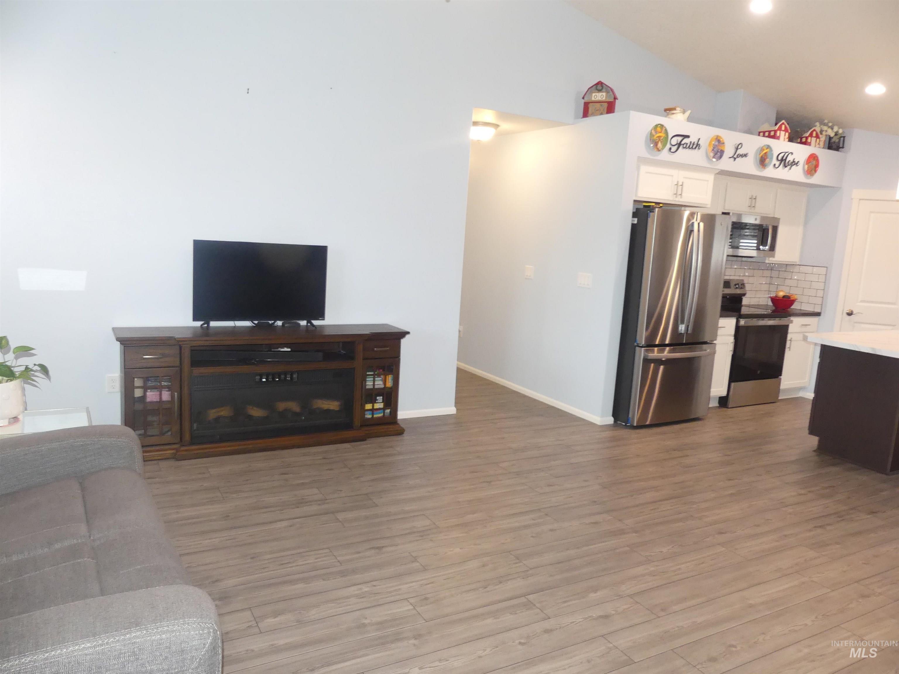 Living room featuring dark wood finished floors and recessed lighting