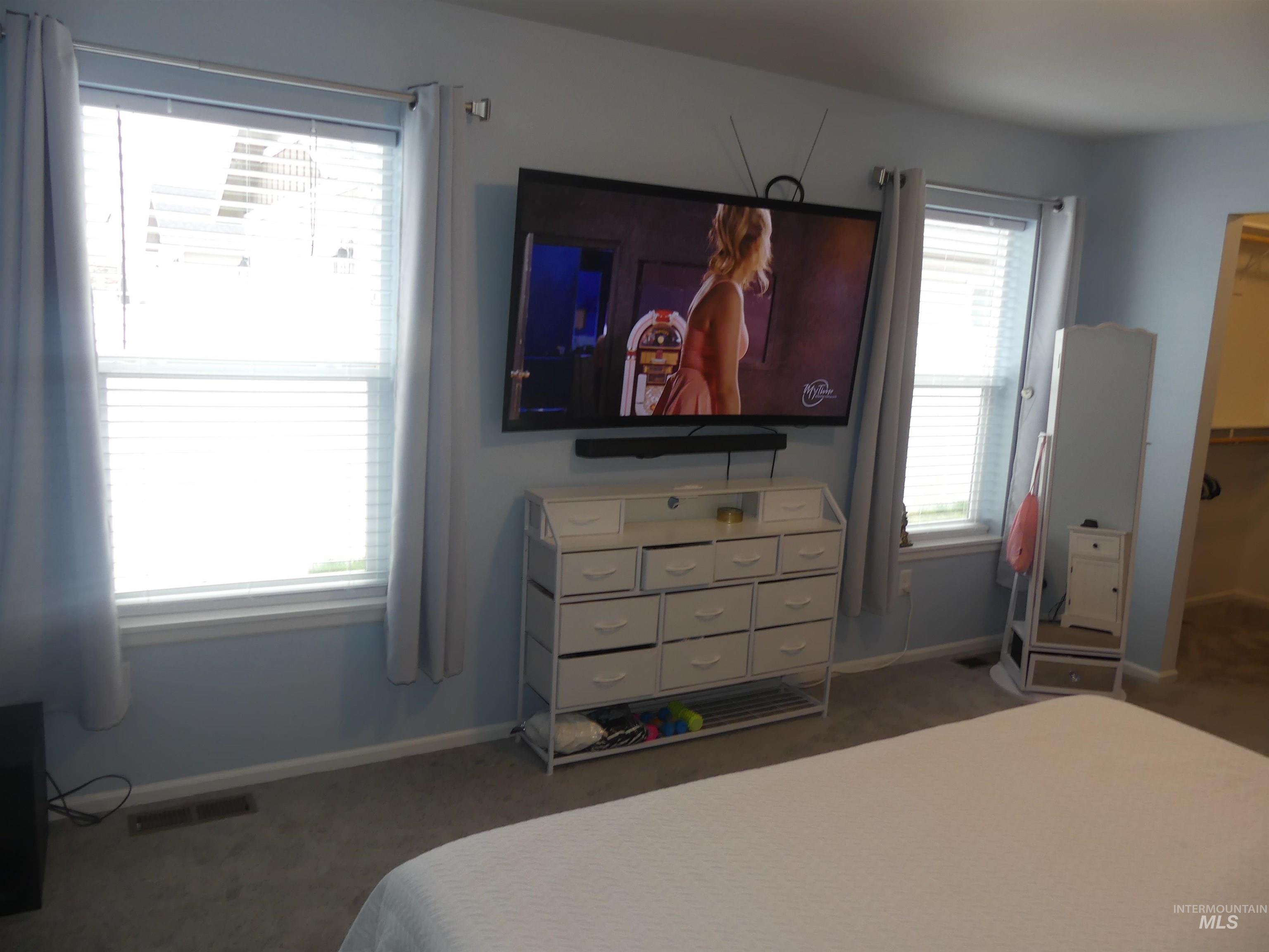 Bedroom with carpet and a spacious closet