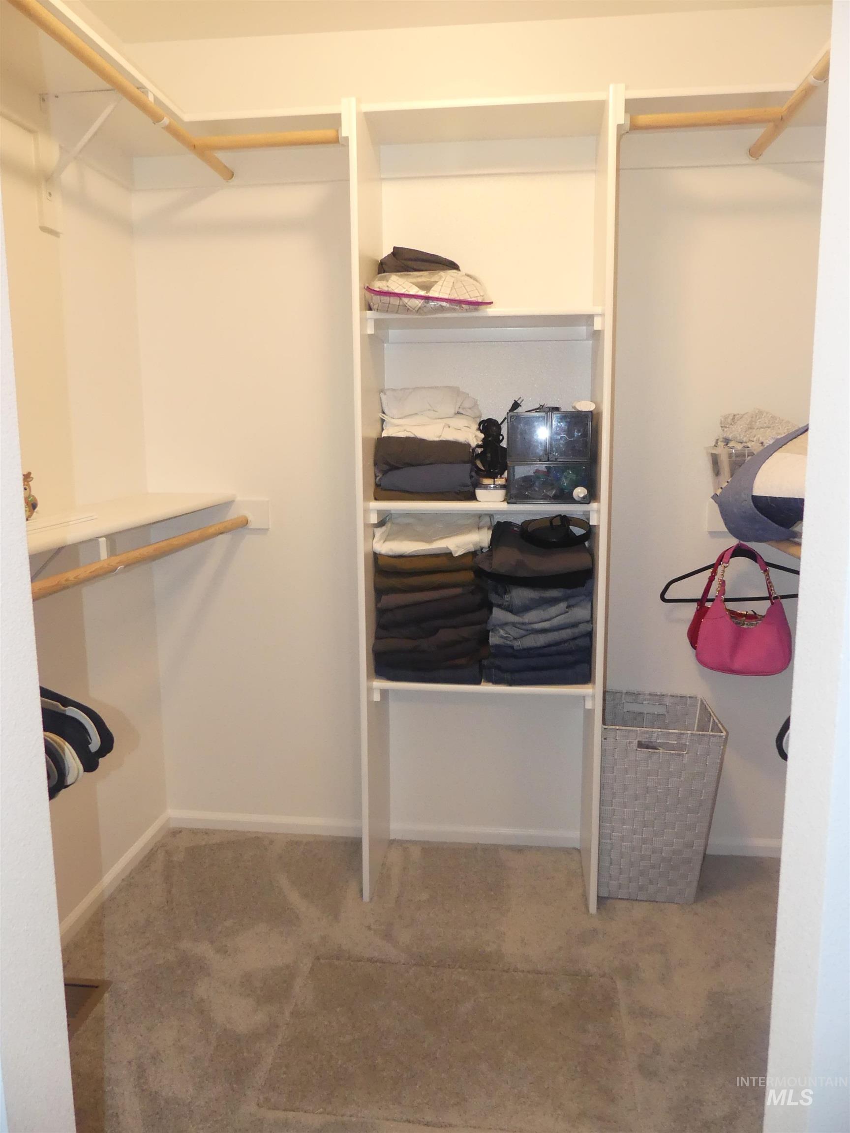 Spacious closet with light colored carpet