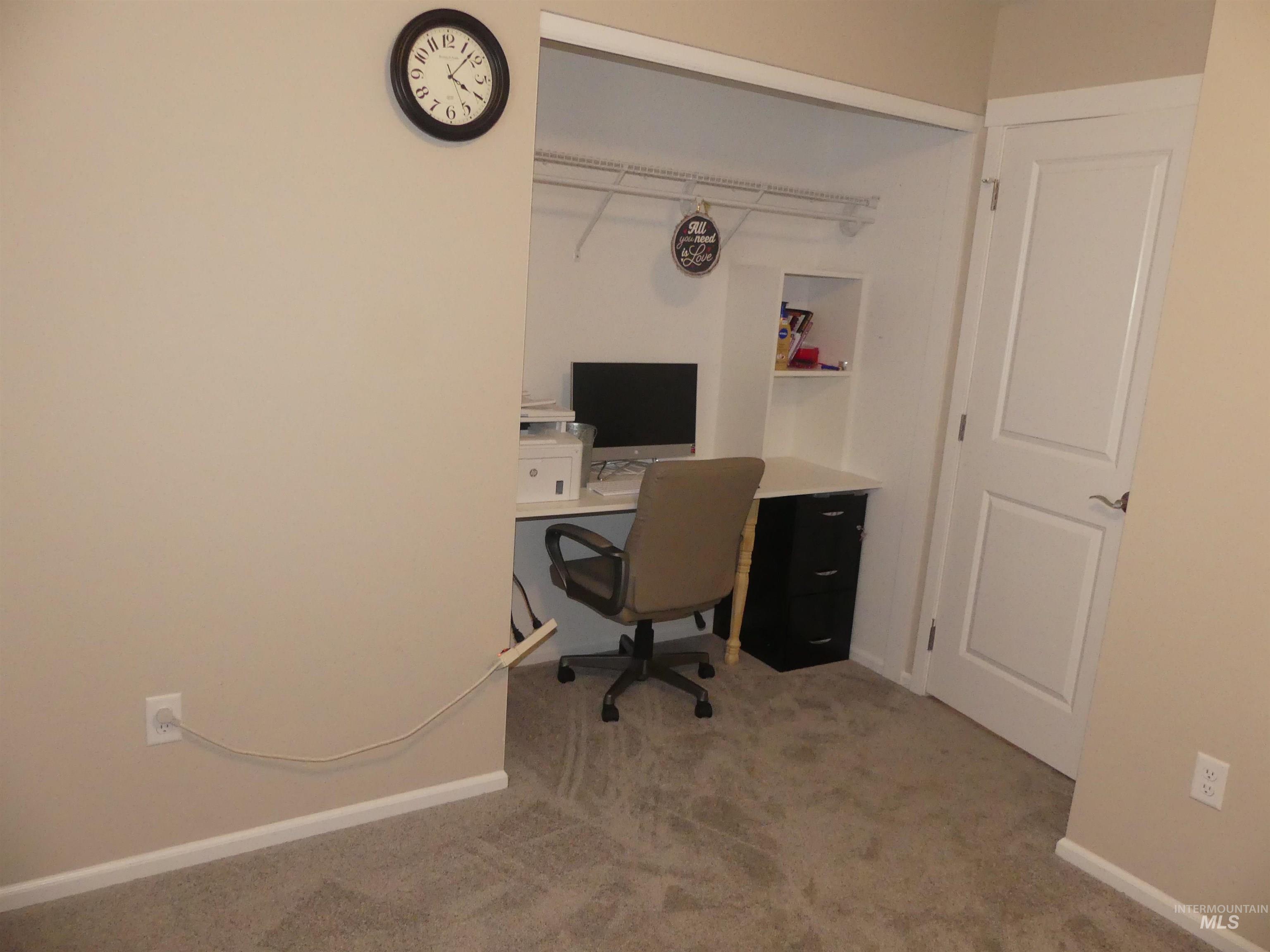 Office featuring light carpet and baseboards