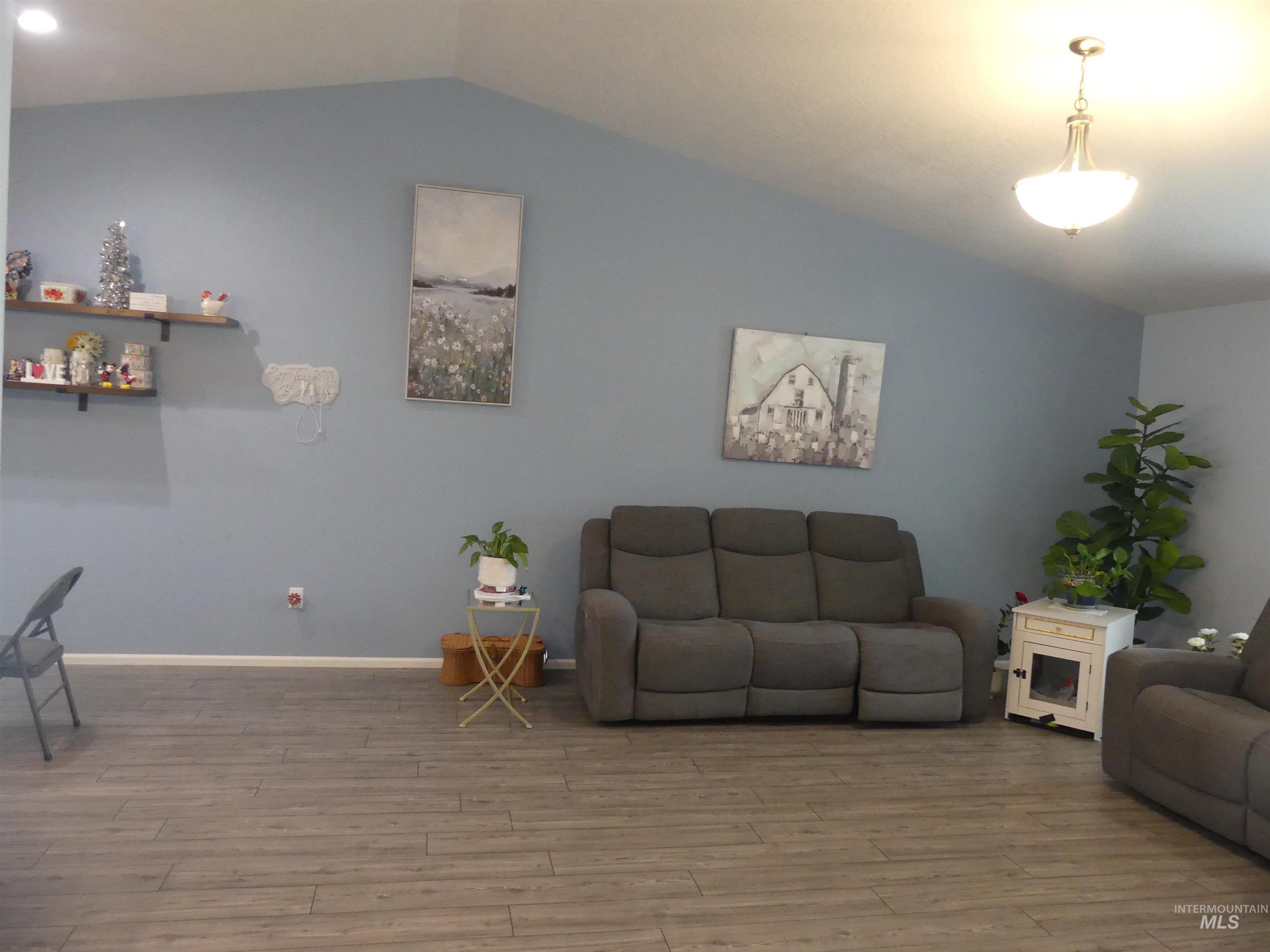 Living room with lofted ceiling and wood finished floors
