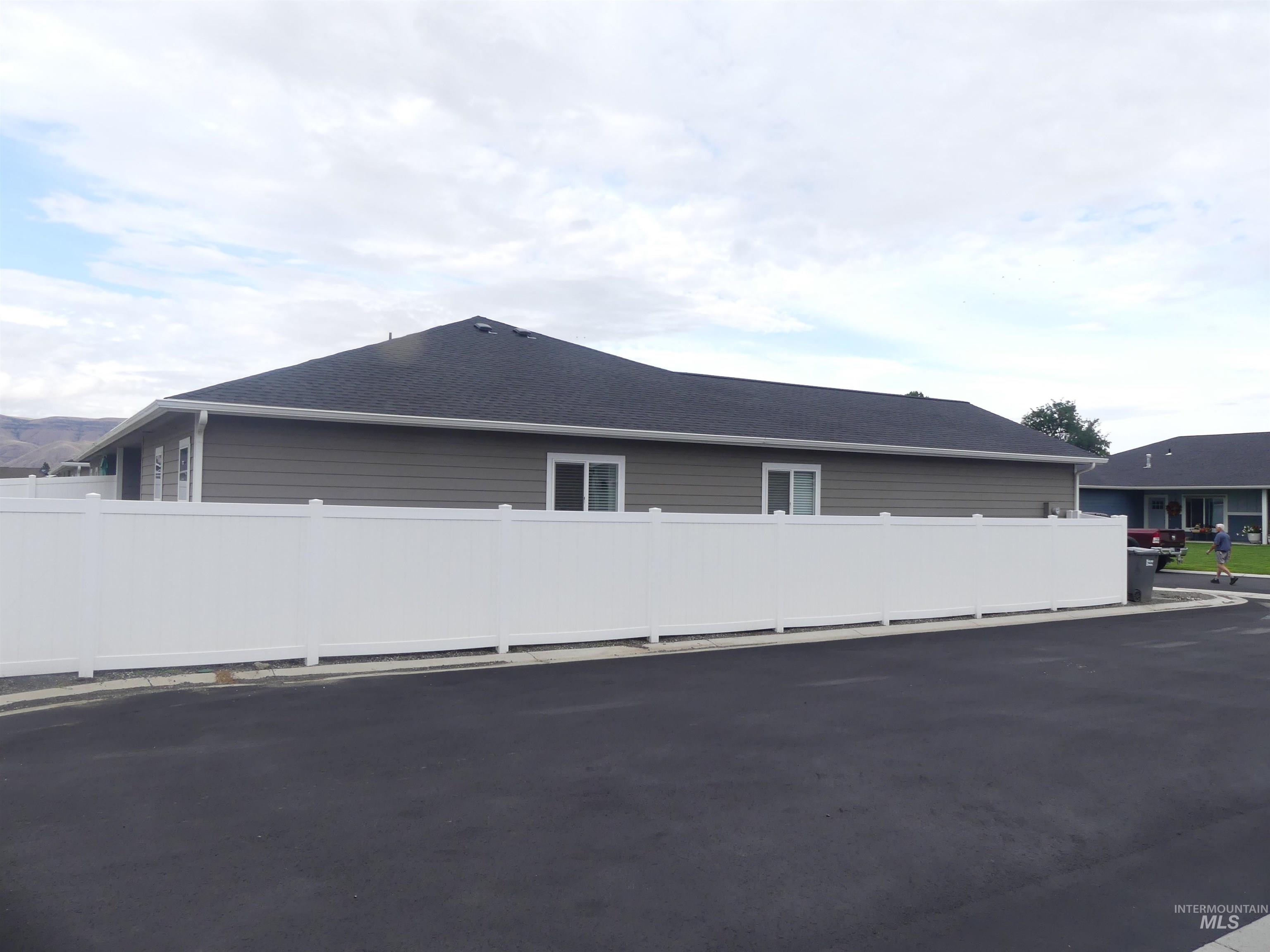 View of side of property featuring roof with shingles