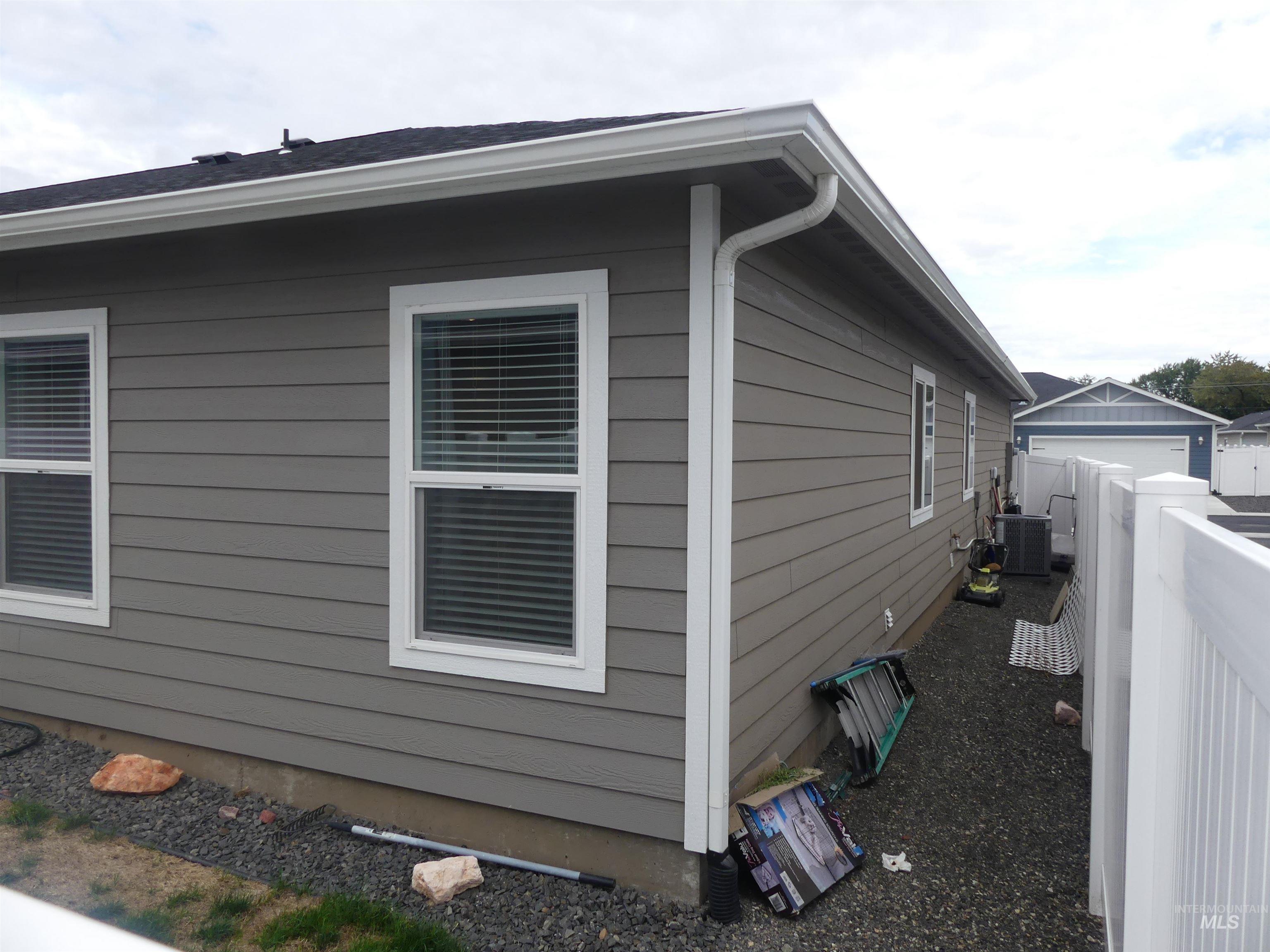 View of property exterior with a cooling unit and a garage