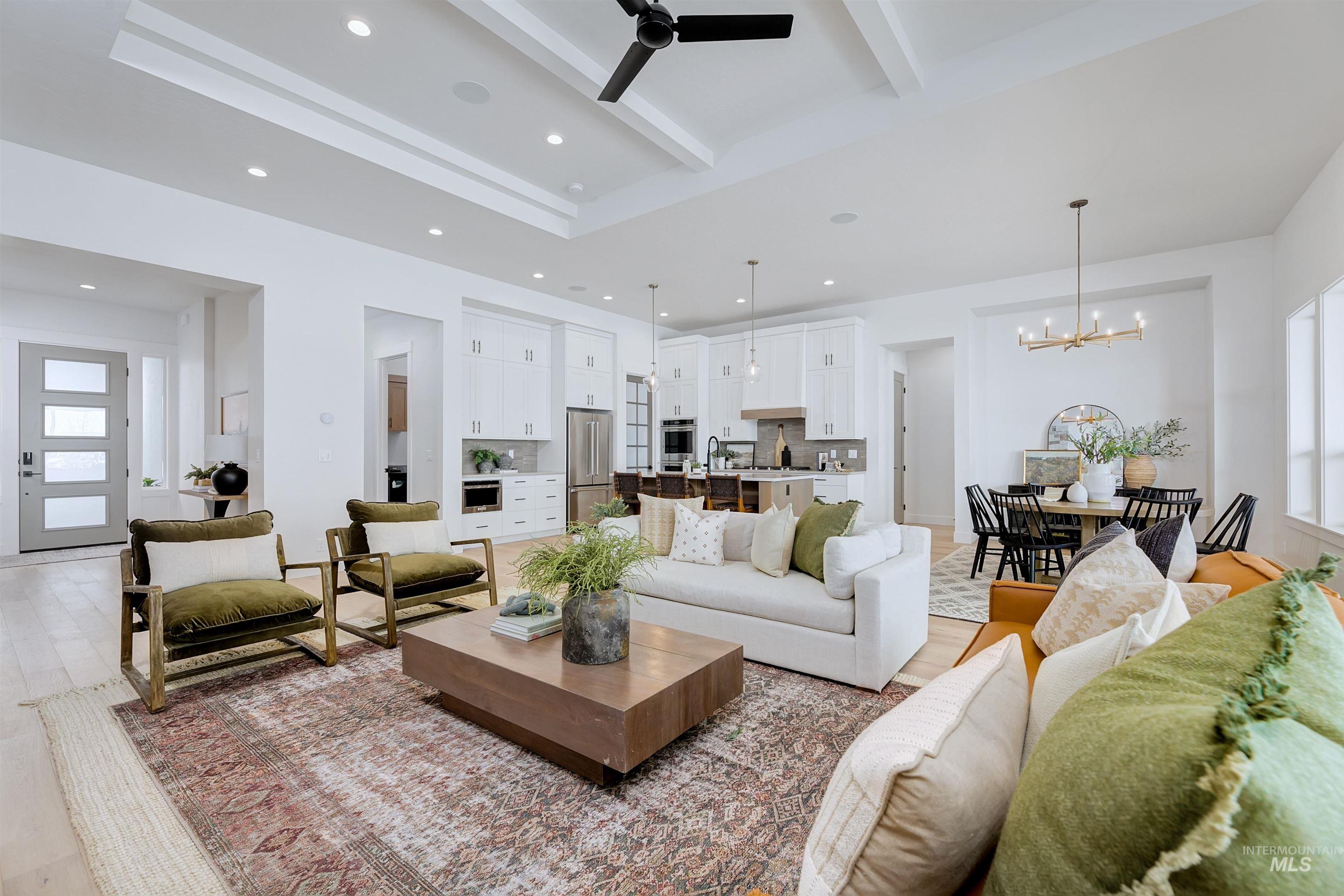 Living room featuring beamed ceiling, recessed lighting, a ceiling fan, light wood-style floors, and a chandelier