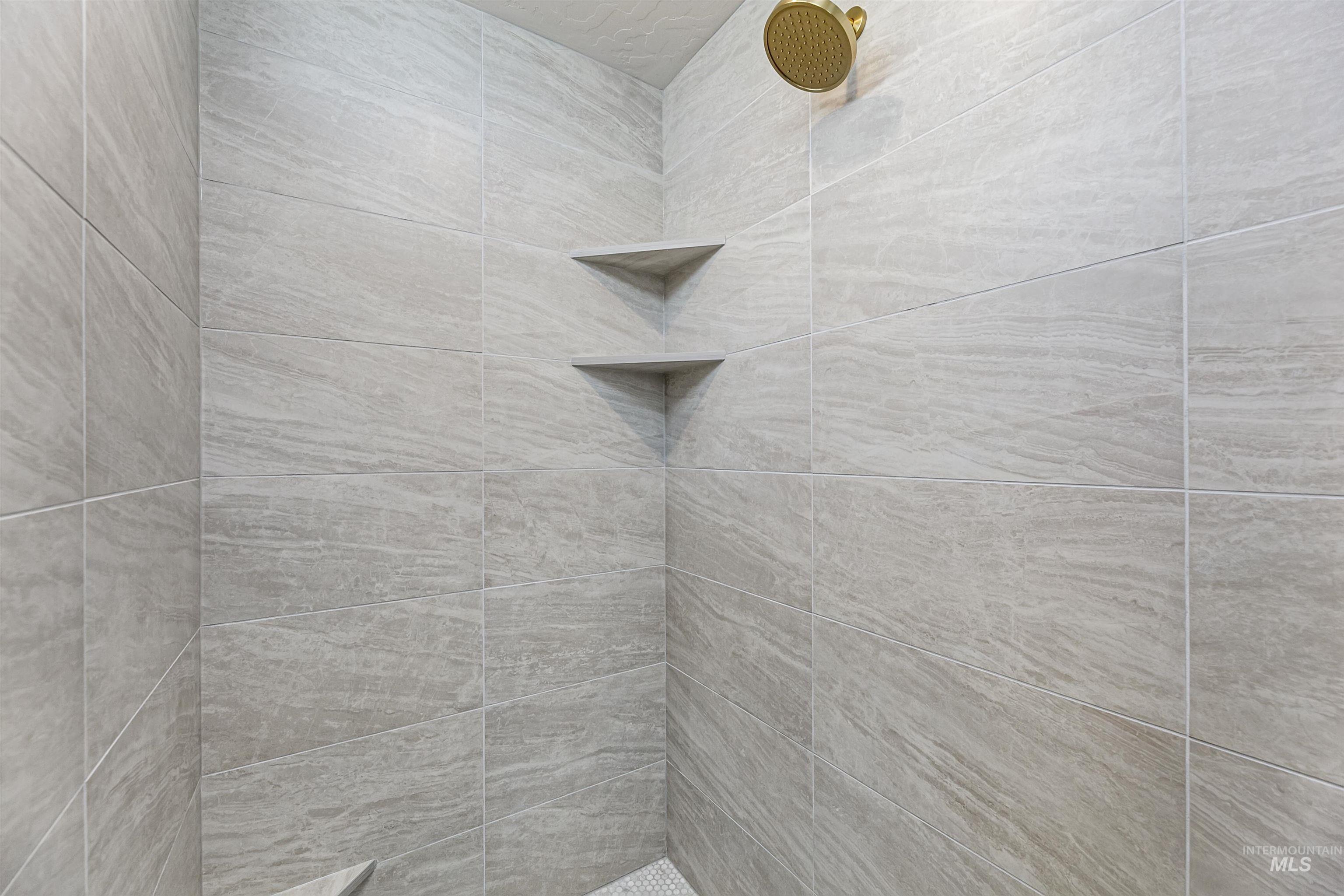 Full bath featuring tiled shower