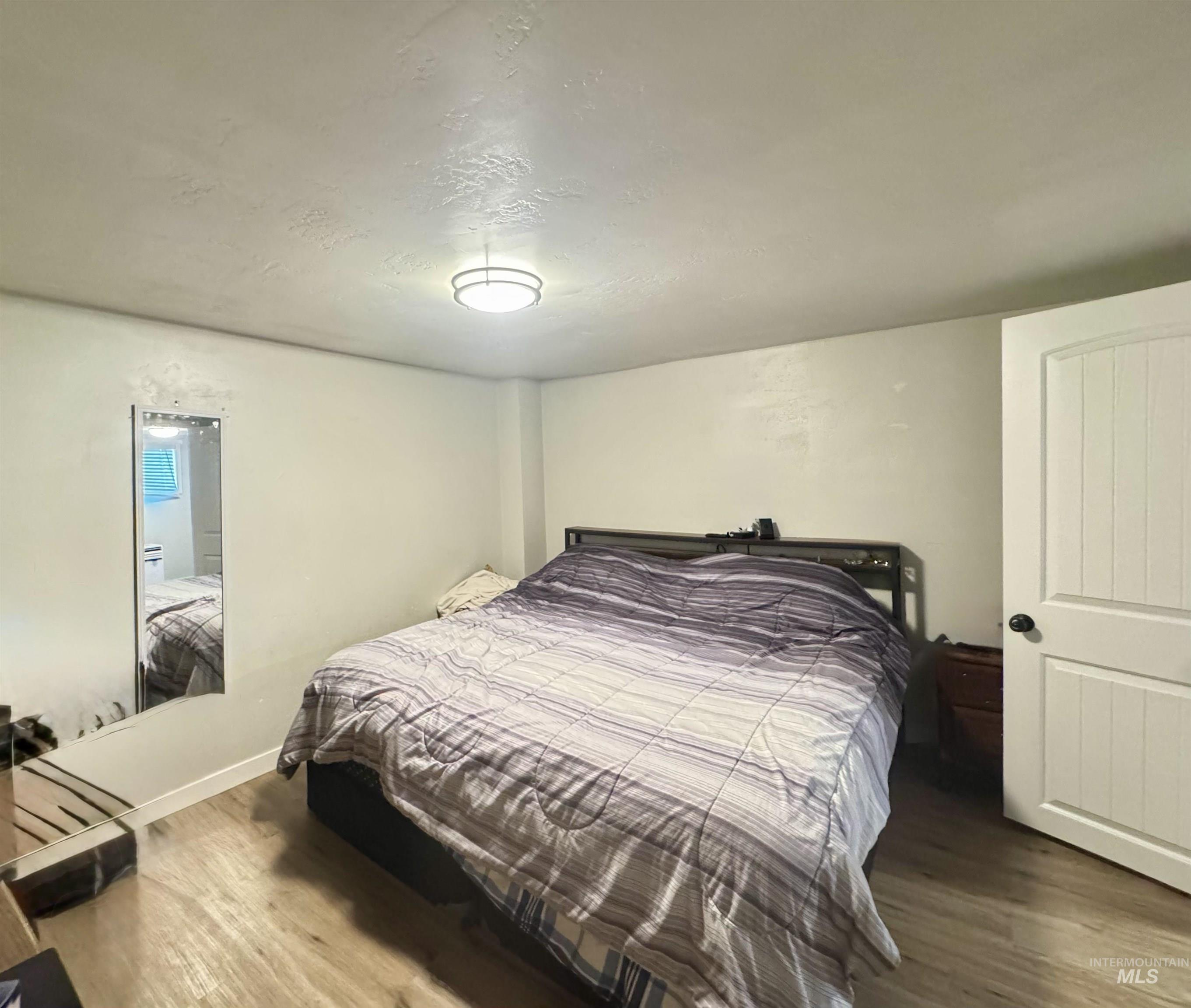 Bedroom with wood finished floors