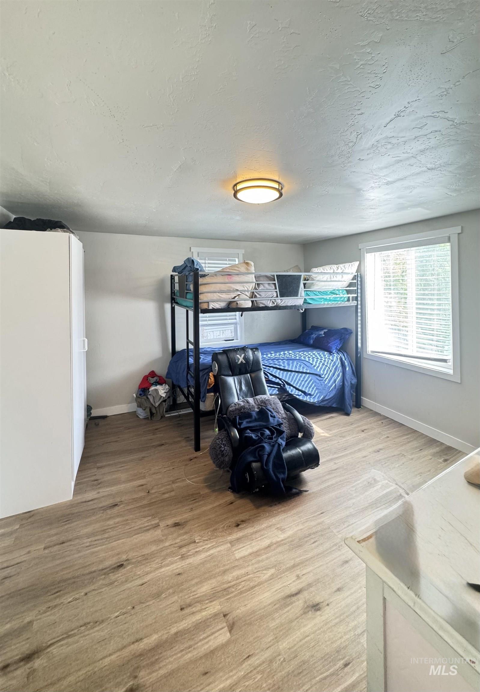 Bedroom featuring light wood-style flooring and a textured ceiling