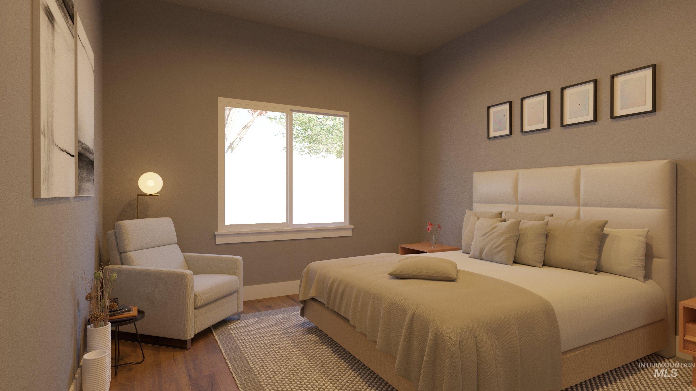 Bedroom featuring wood finished floors and baseboards