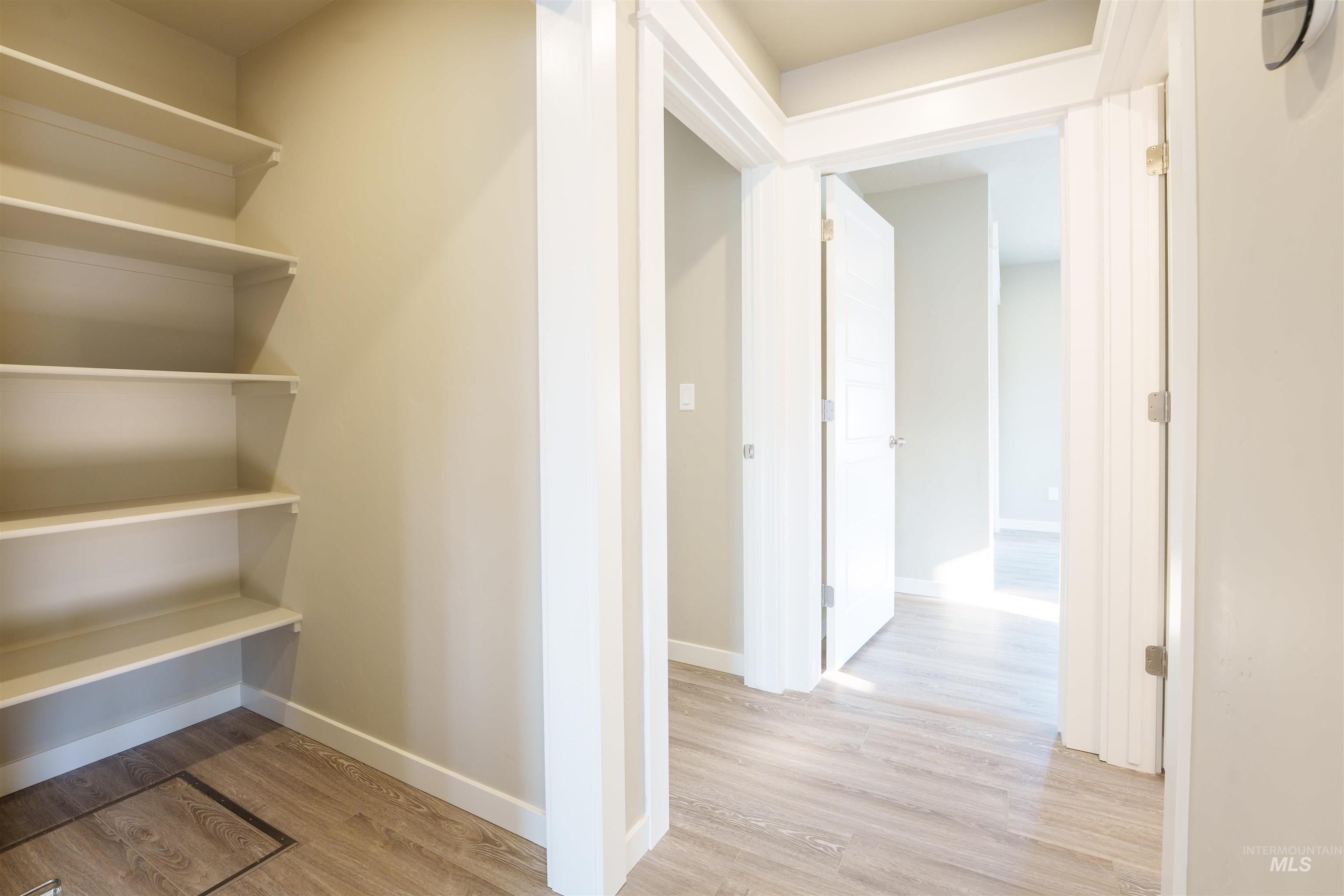 Hall with light wood-style flooring