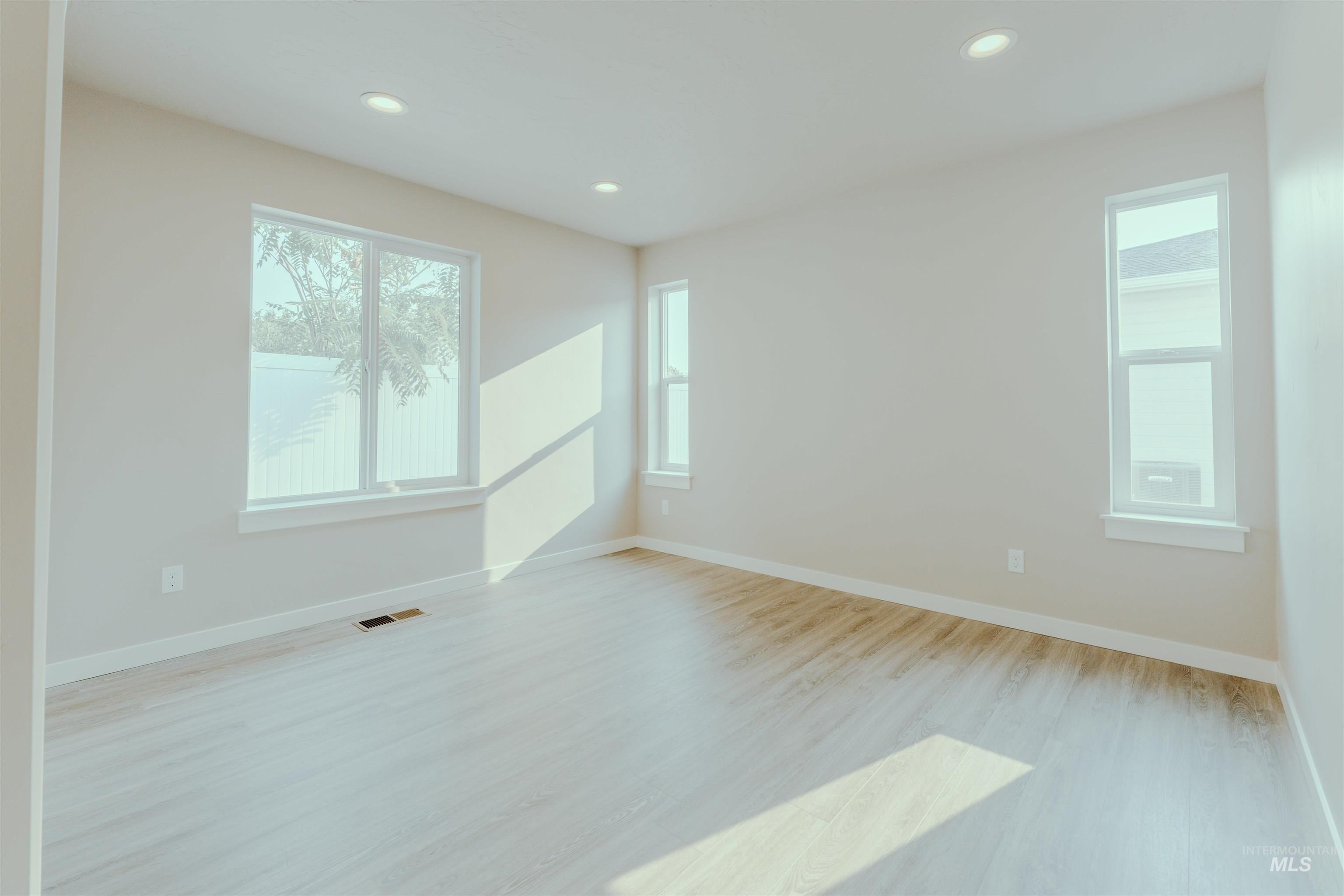 Unfurnished room with light wood finished floors and recessed lighting