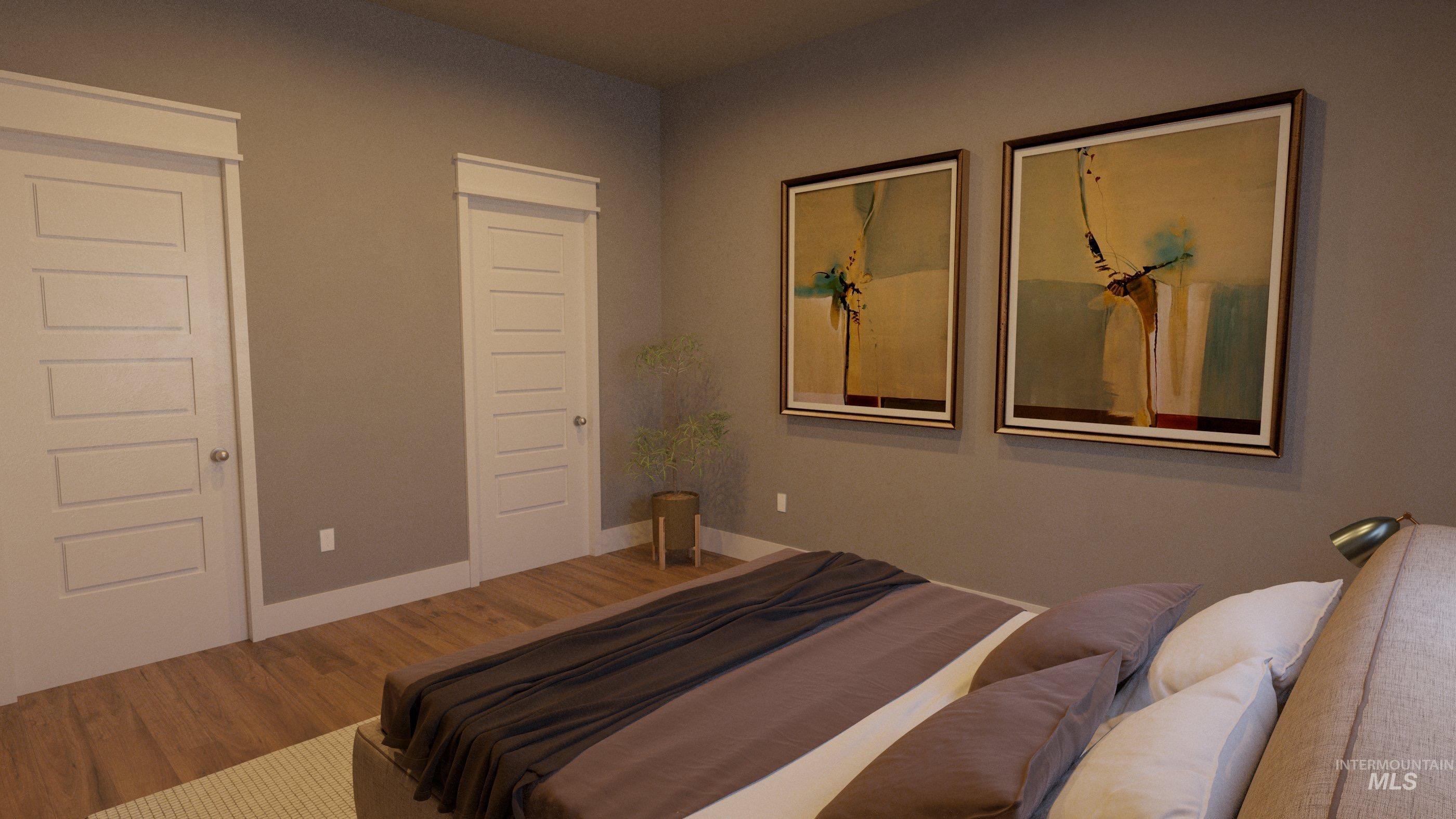 Bedroom featuring wood finished floors and baseboards