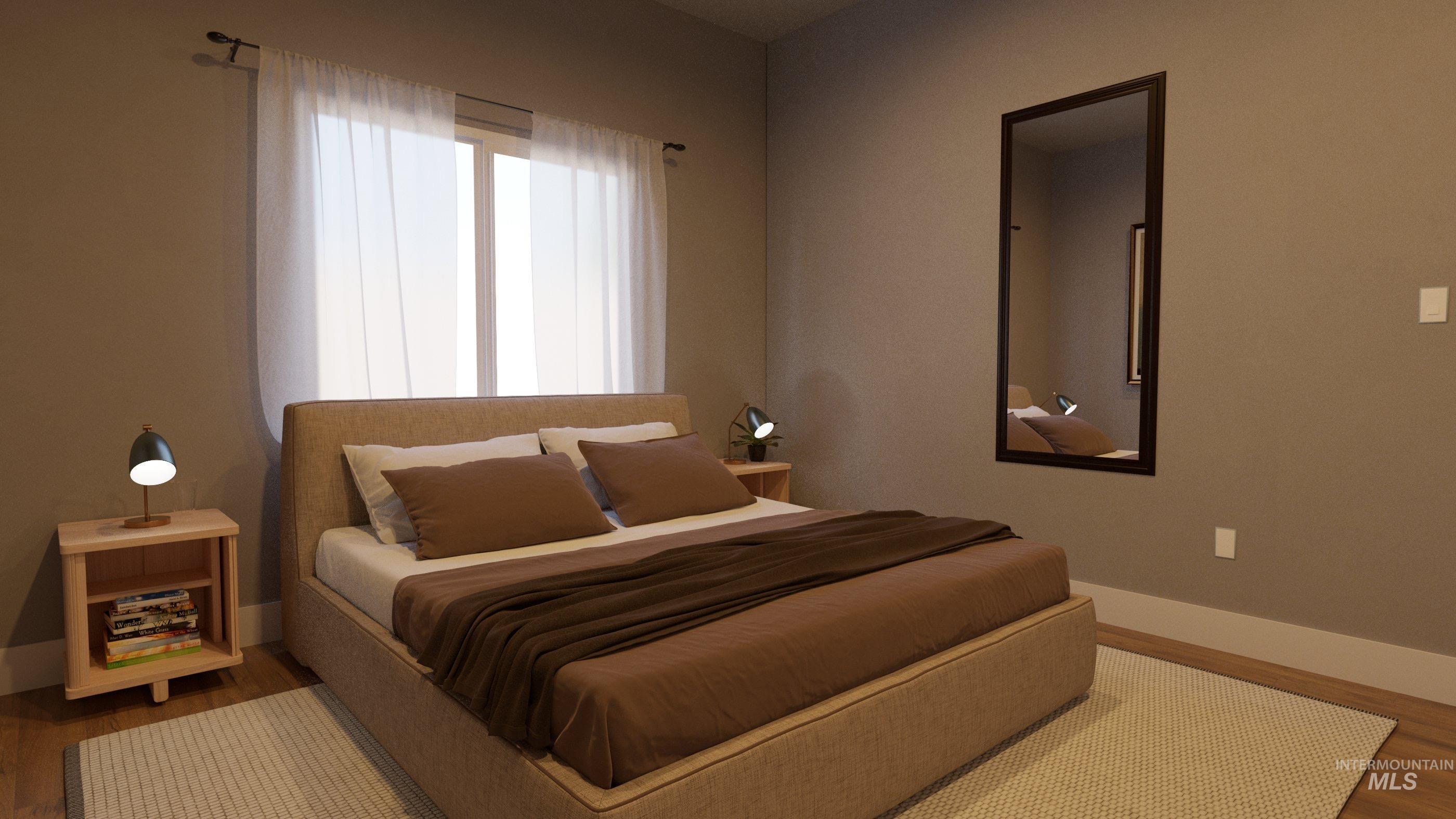 Bedroom with wood finished floors and baseboards