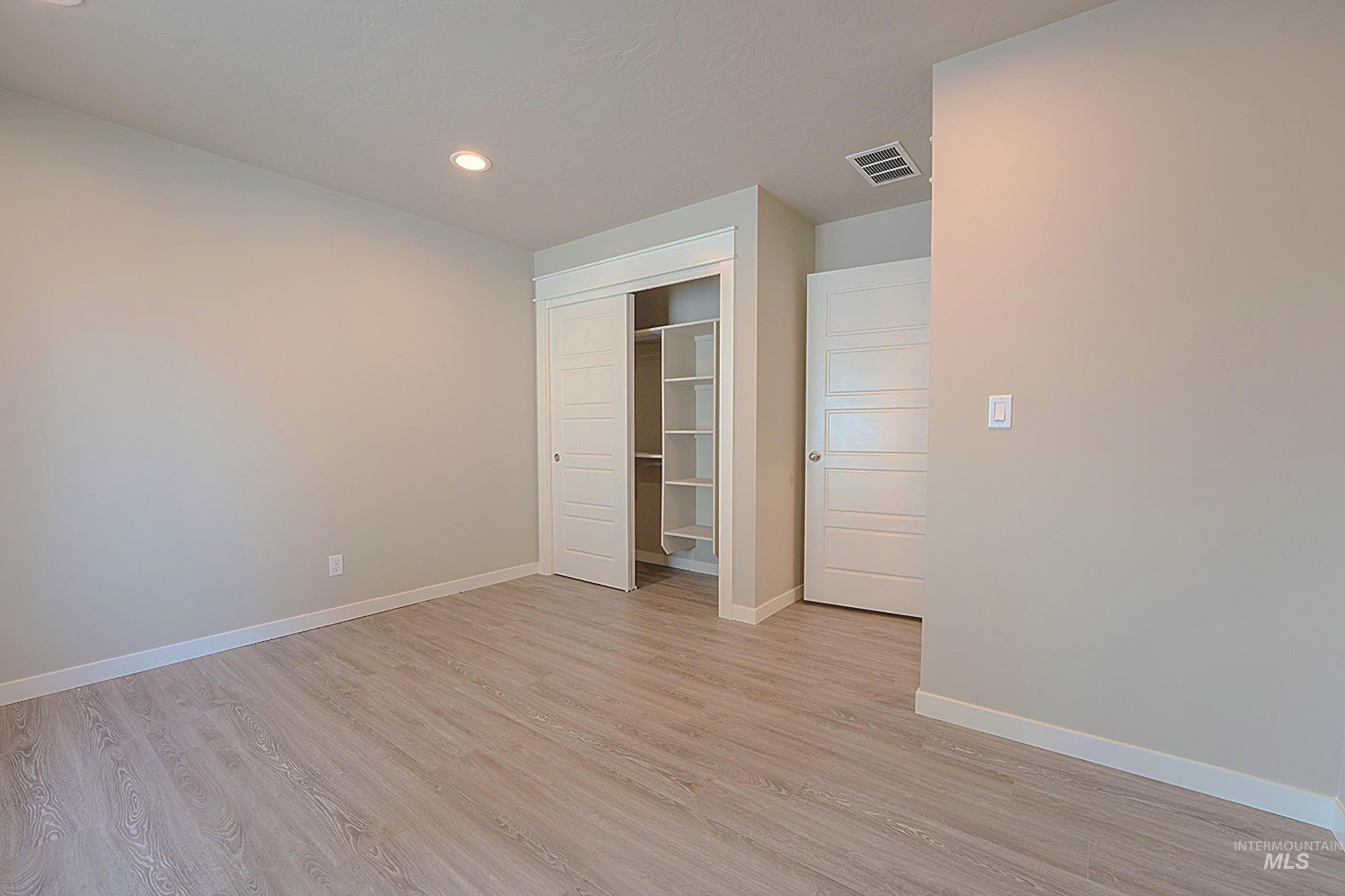 Unfurnished bedroom featuring recessed lighting, light wood-type flooring, and a closet