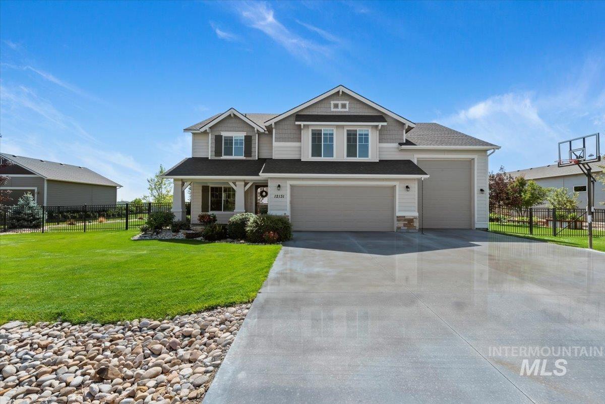 Craftsman-style home with driveway, covered porch, an attached garage, roof with shingles, and a garage