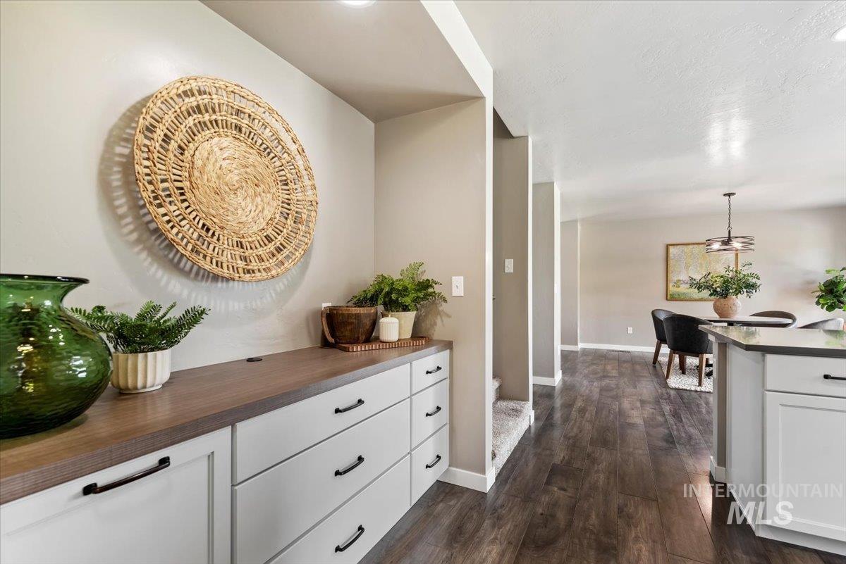 Hallway with baseboards and dark wood finished floors