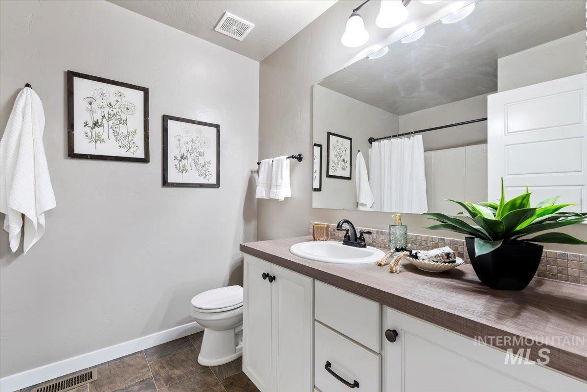 Bathroom with vanity and curtained shower
