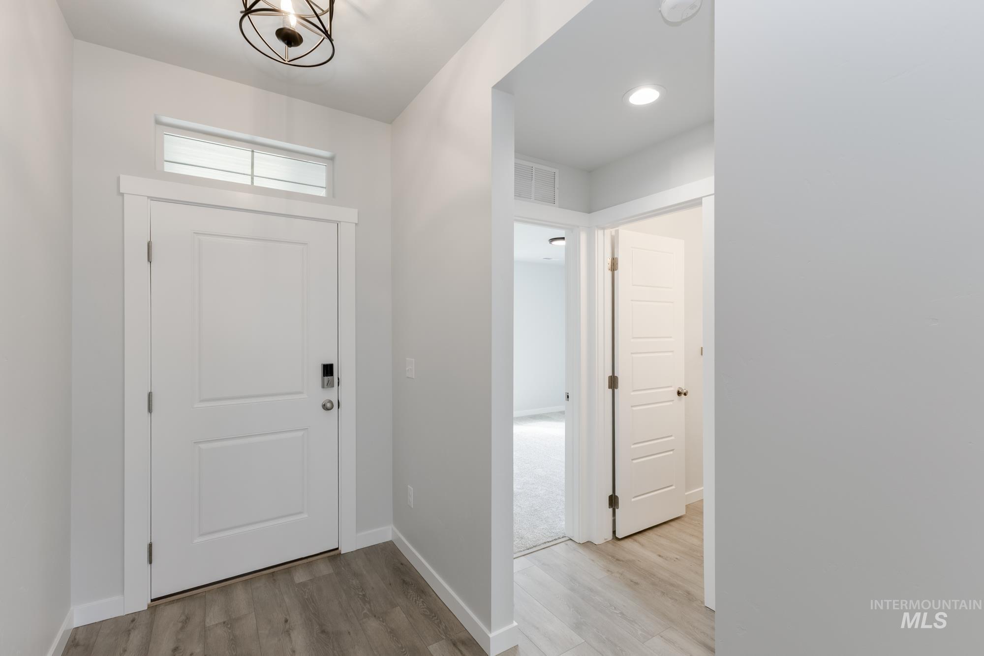 Foyer featuring light wood-style flooring and recessed lighting
