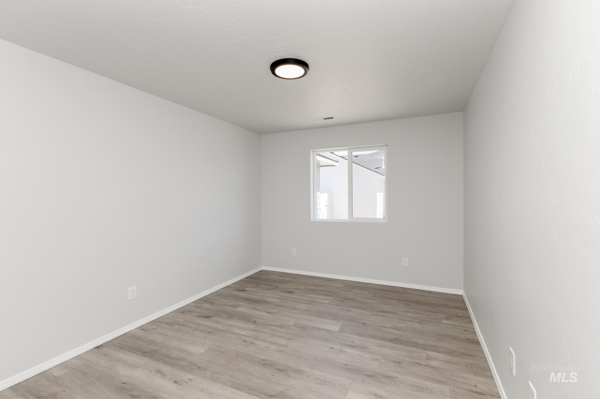 Empty room featuring light wood-style floors and baseboards