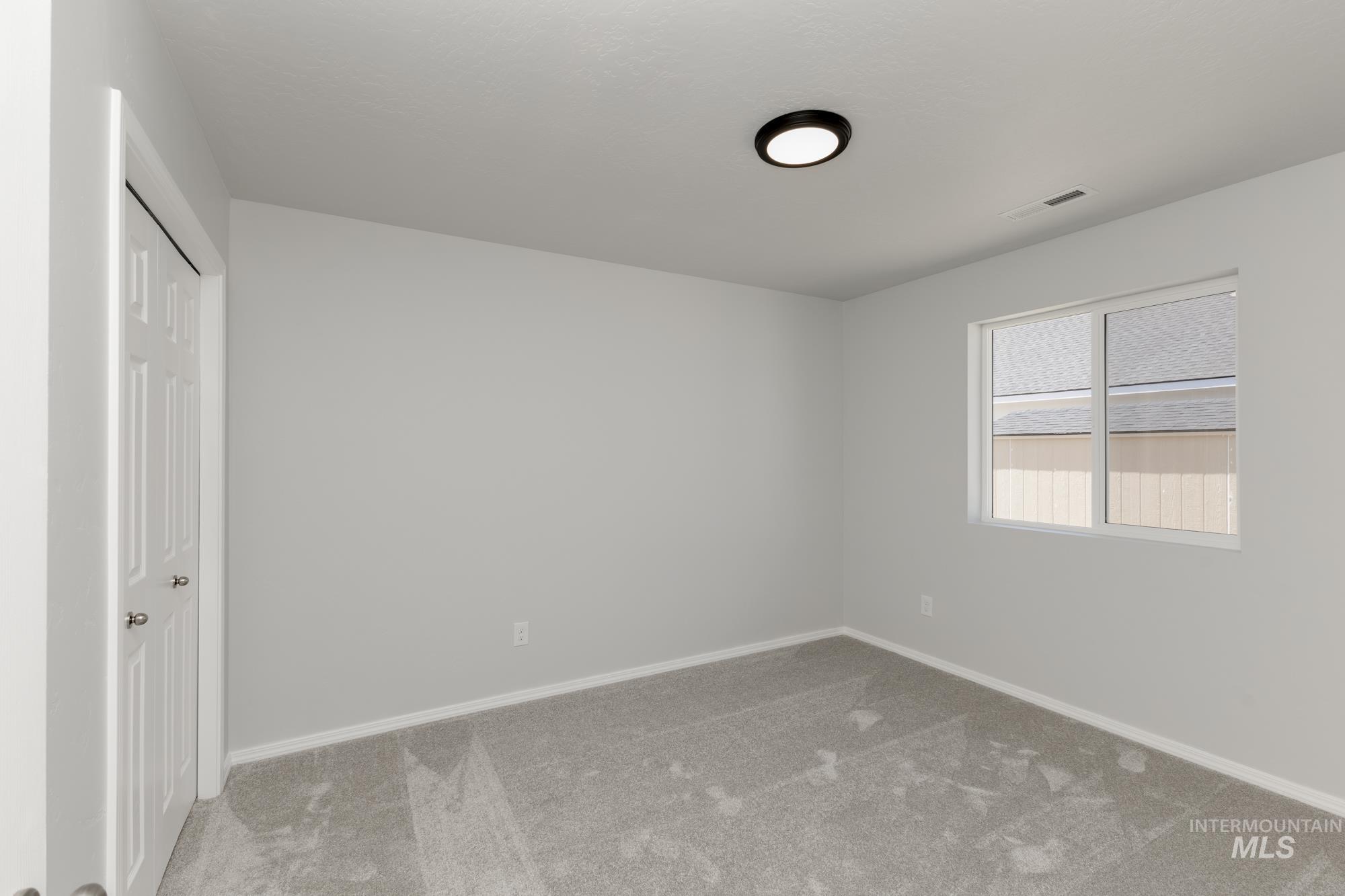 Unfurnished bedroom with carpet flooring and a closet