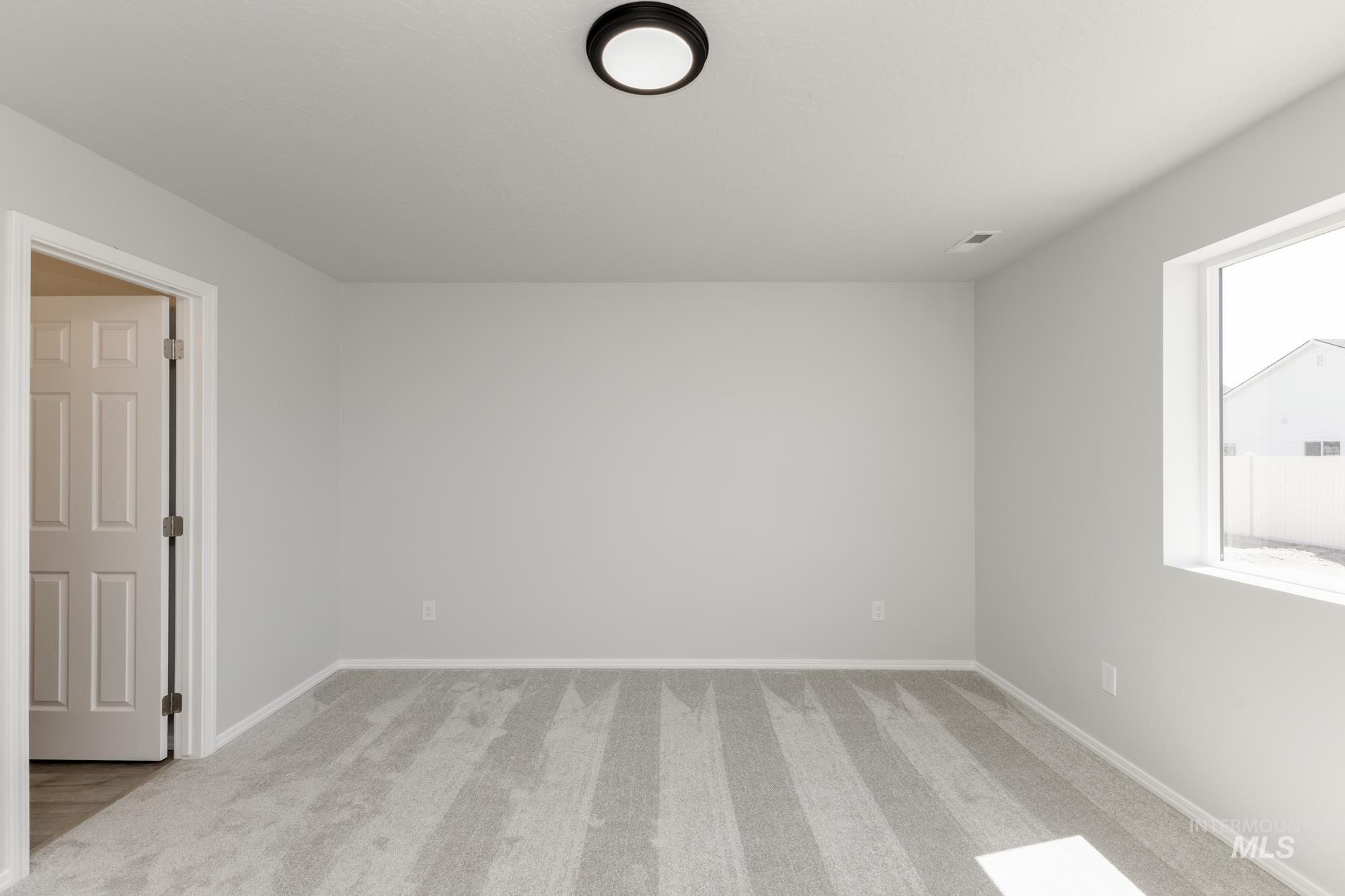 Unfurnished room with light colored carpet