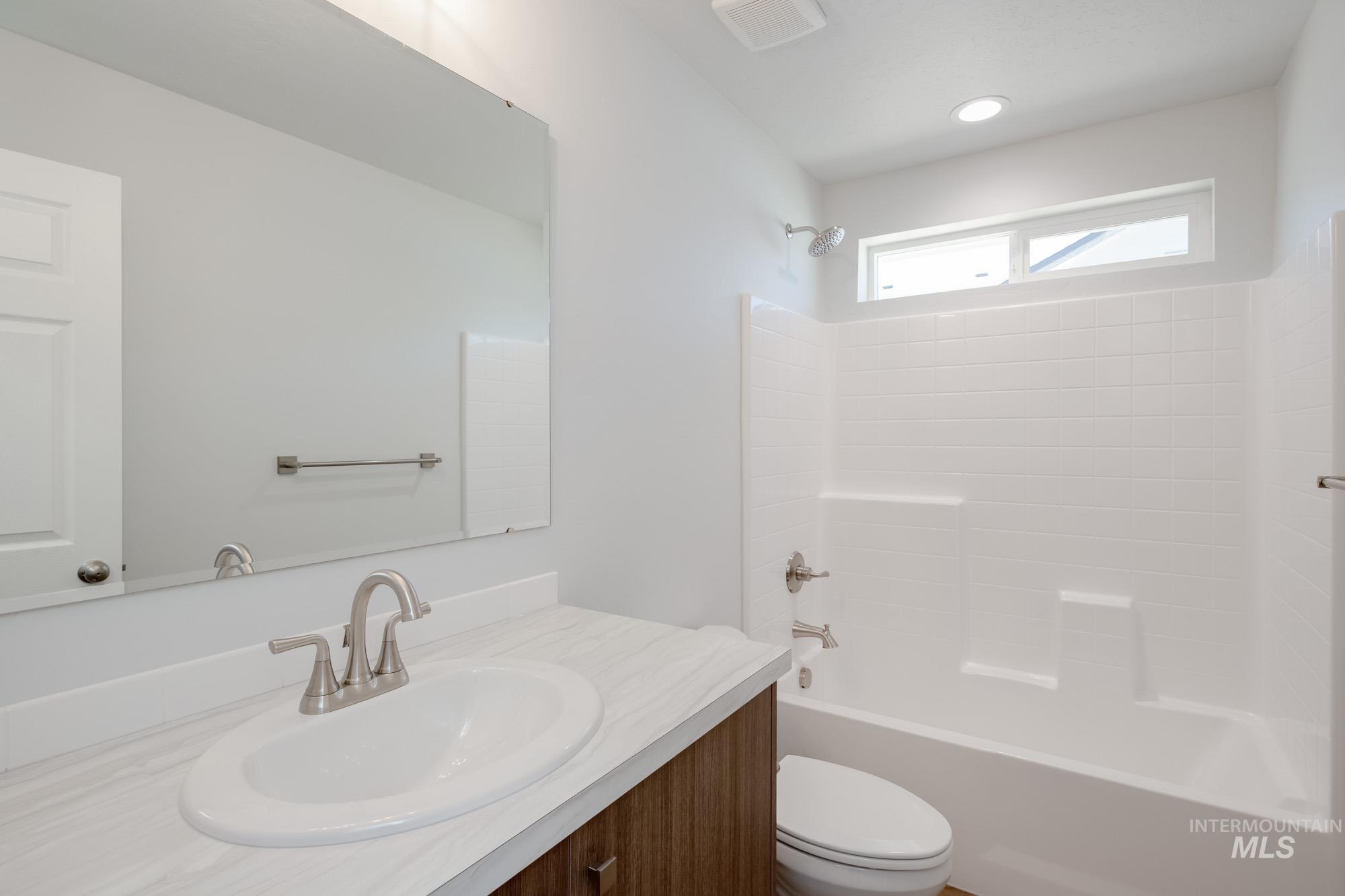 Bathroom featuring vanity and shower / bathtub combination