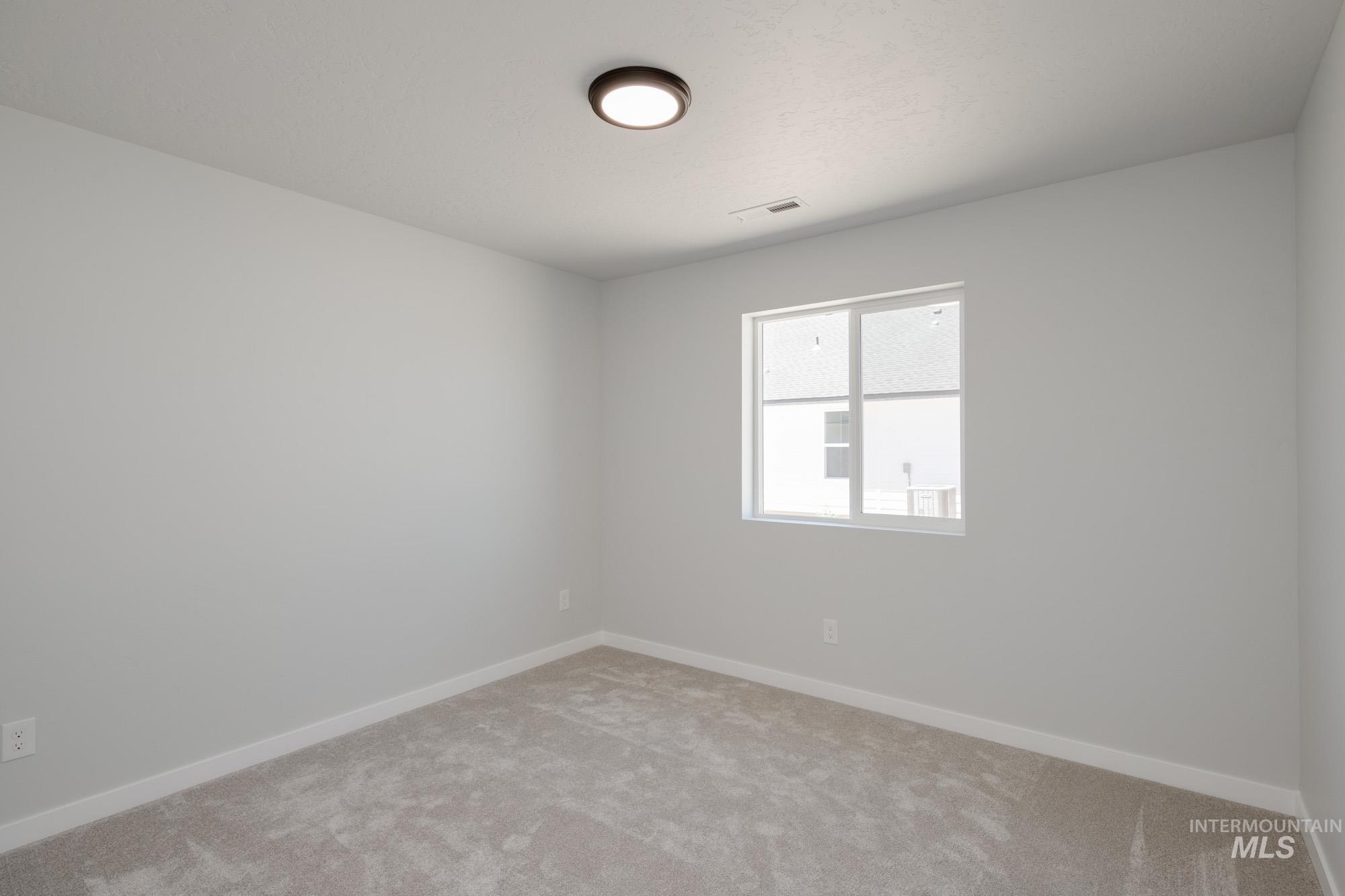 Unfurnished room featuring light carpet