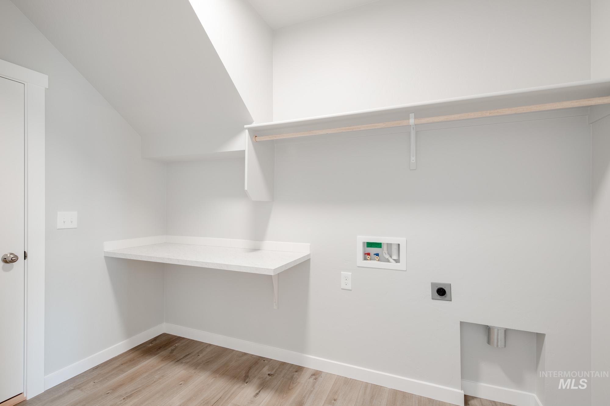 Laundry room featuring electric dryer hookup, washer hookup, and light wood-style flooring
