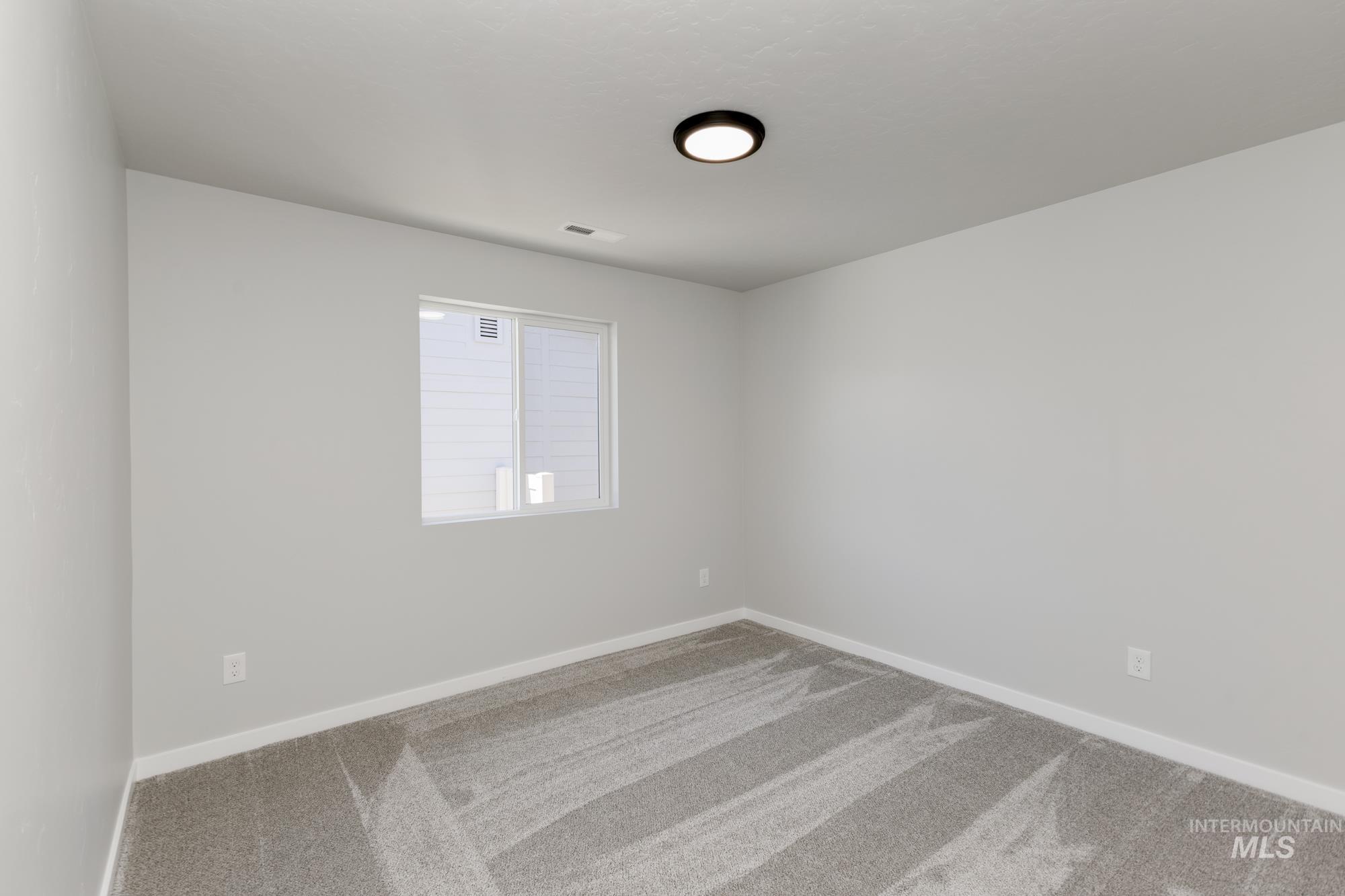 Unfurnished room with carpet and baseboards