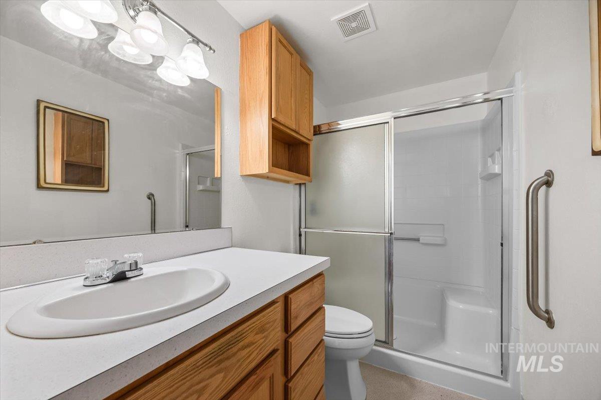 Bathroom with vanity and a stall shower